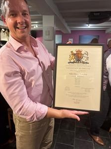 Man with large certificate