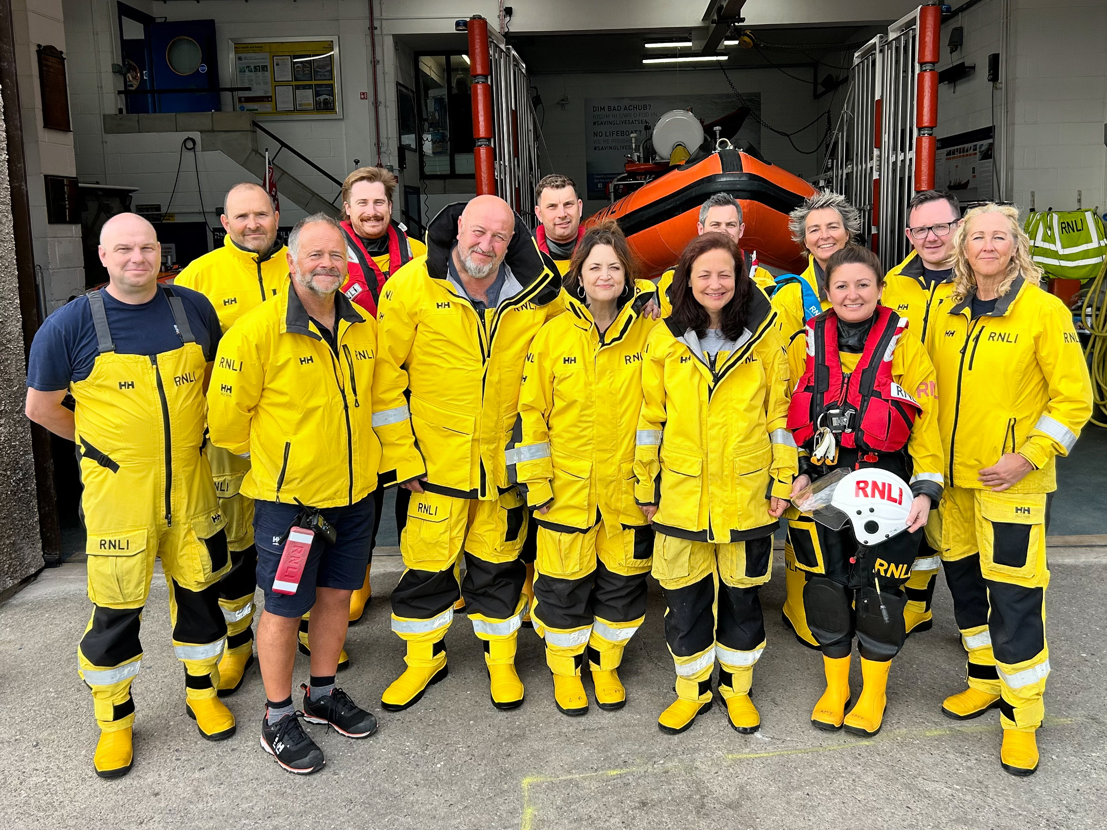 The photo shows both Barry Dock and Penarth RNLI volunteer crew with Ruth, Steve and Maria outside the boathouse
