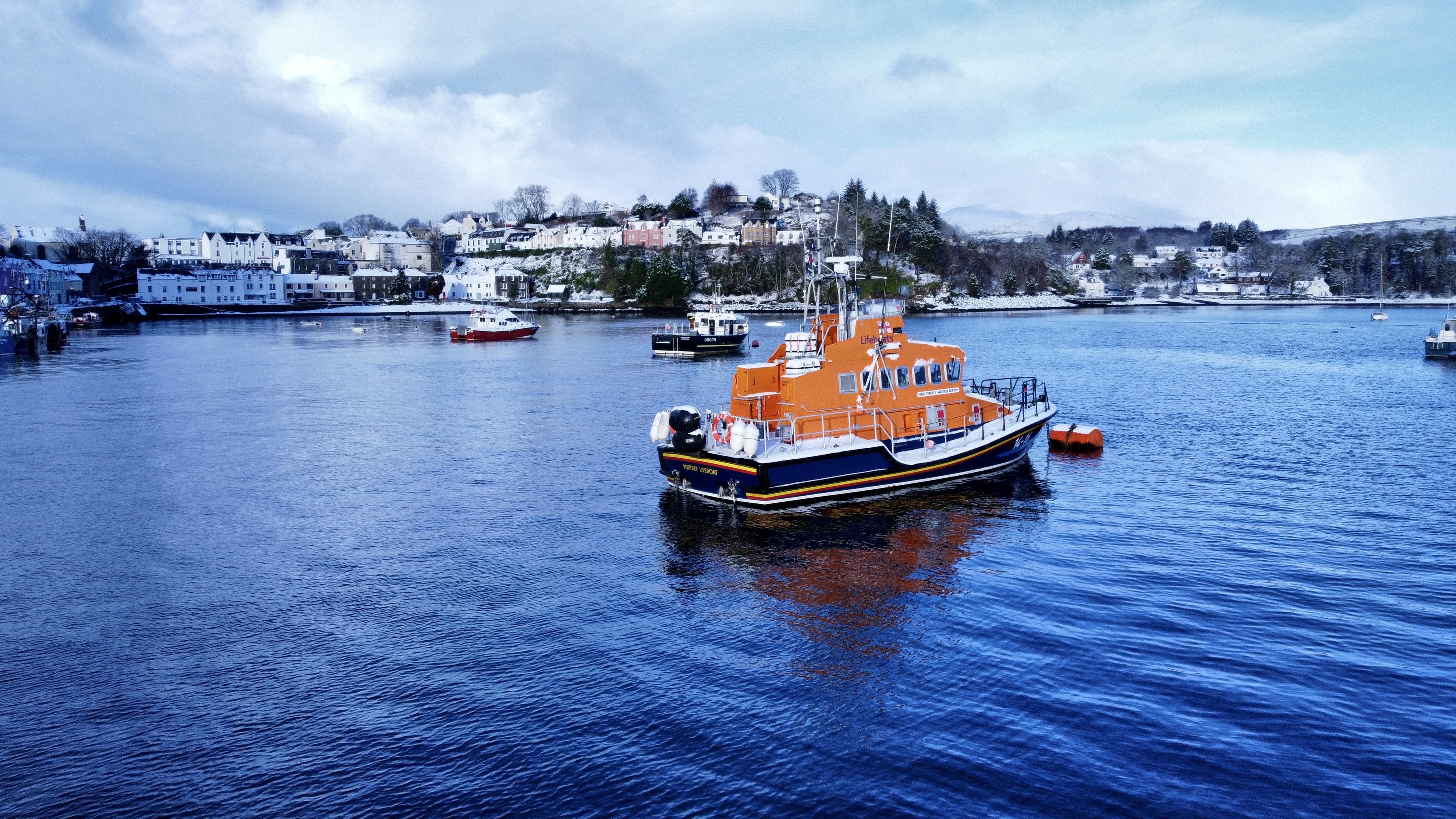 Portree lifeboat Stanley Watson Barker pictured in a snowy Portree harbour