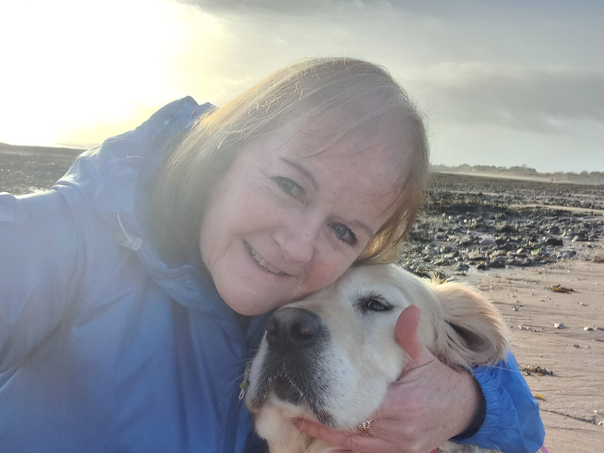 Andrea embracing Seren on the beach 