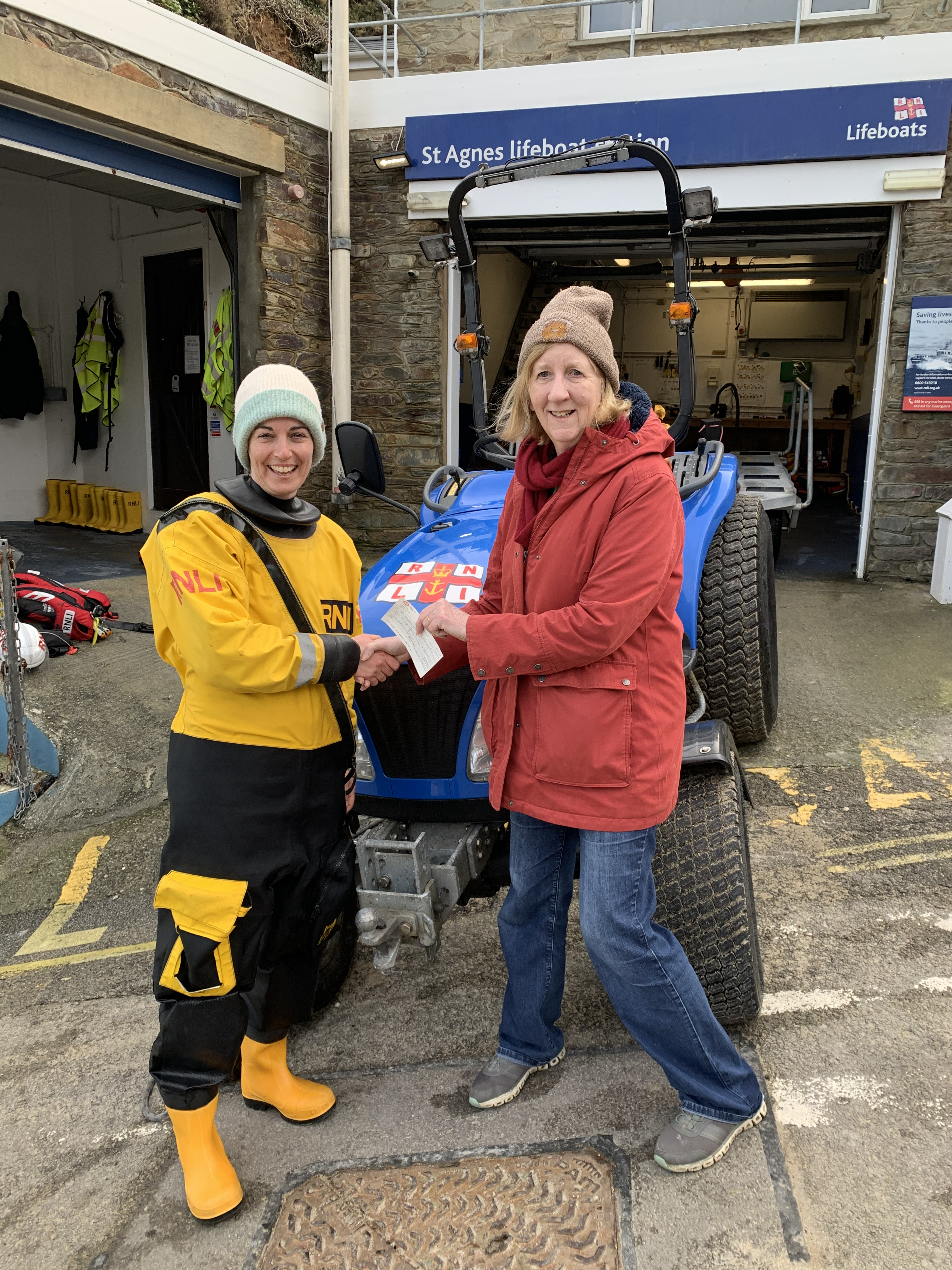 Lambriggan Court owner Fiona Crossley presents a cheque to St Agnes RNLI crew member Laura Penhaul