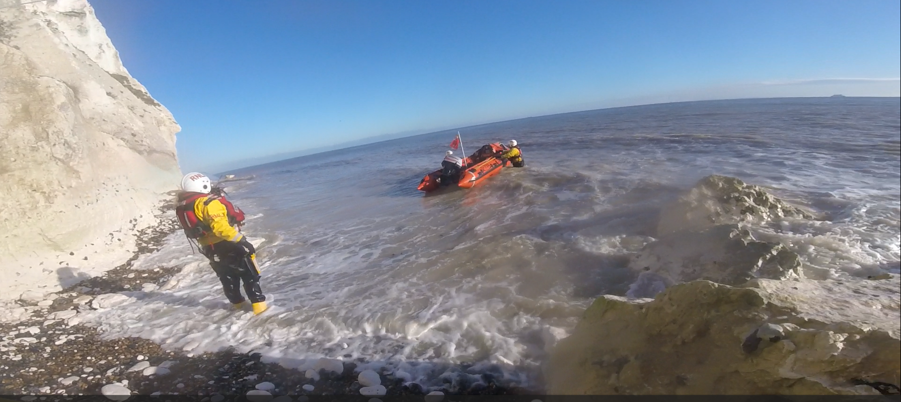 Crew under the cliffs