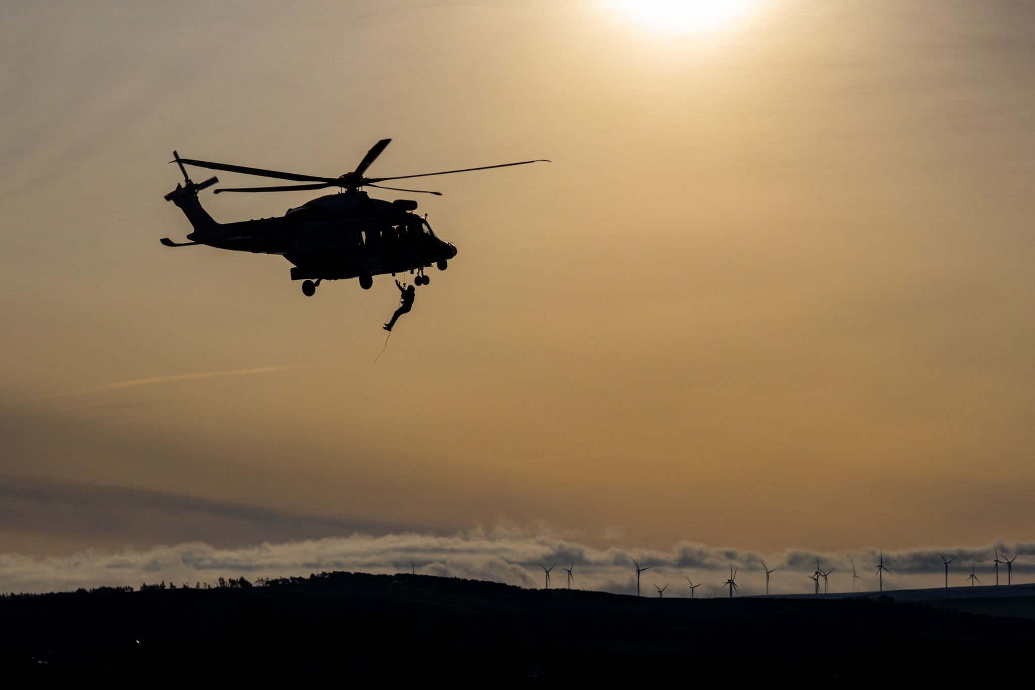 Man hanging from helicopter