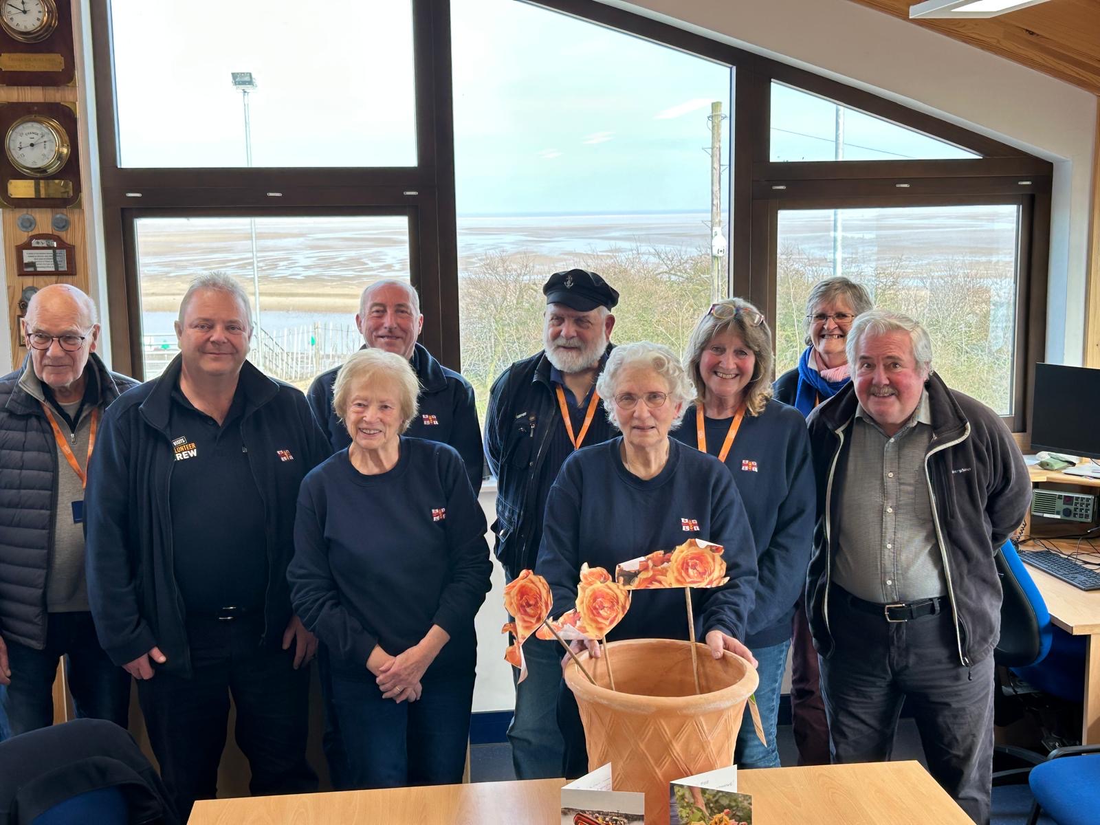 Shelia Warner MBE and Wells RNLIs Visits team at station celebration In crew room