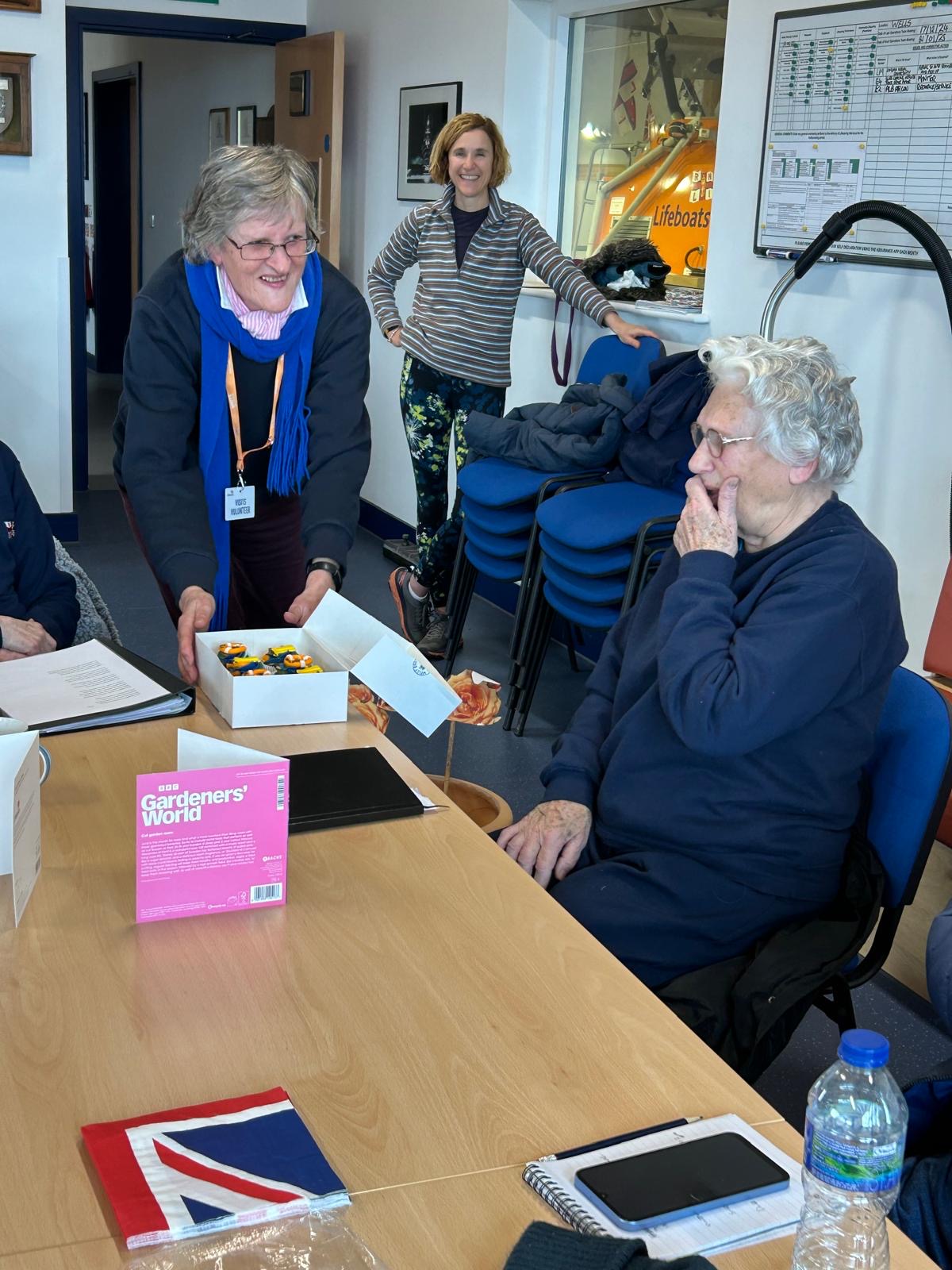 Shelia Warner MBE receiving presents and cupcakes at celebration in crew room