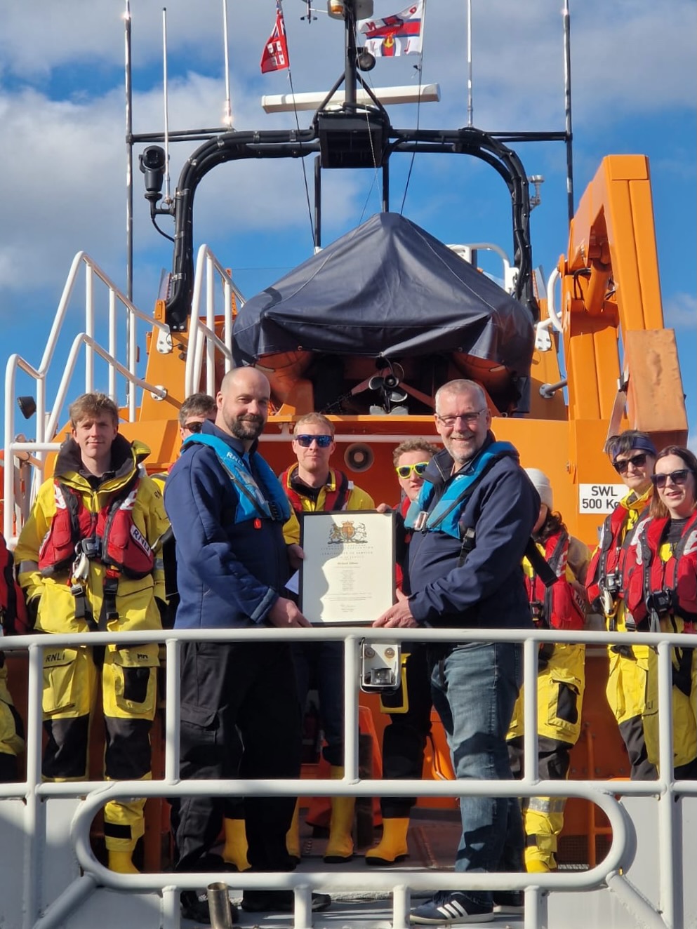 Richard Gibson being presented with his Certificate of Service on Vellum from Lifeboat Operations Manager Nigel Gray