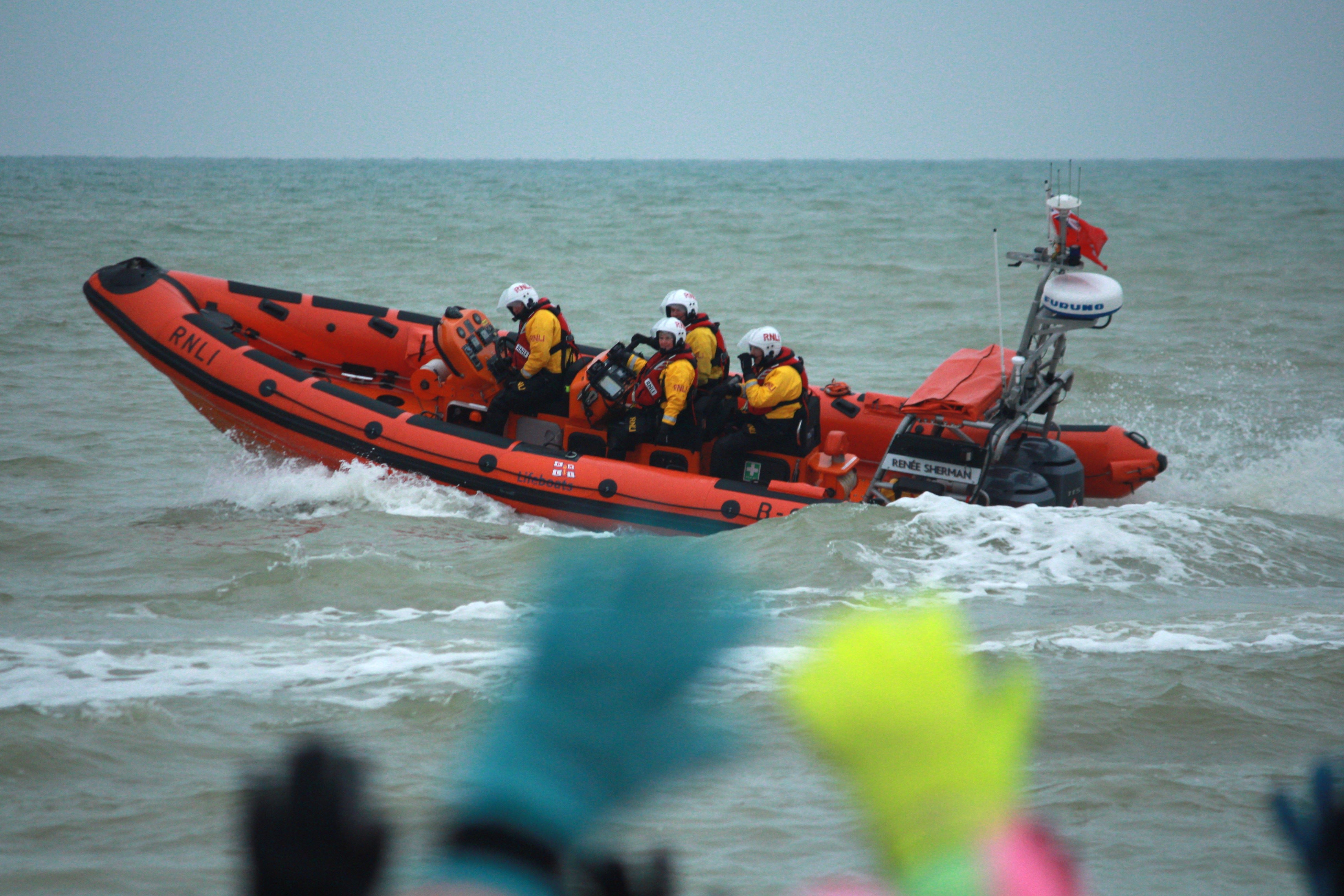 Participants wave at Littlehampton Lifeboats as the dippers prepare to enter the water.