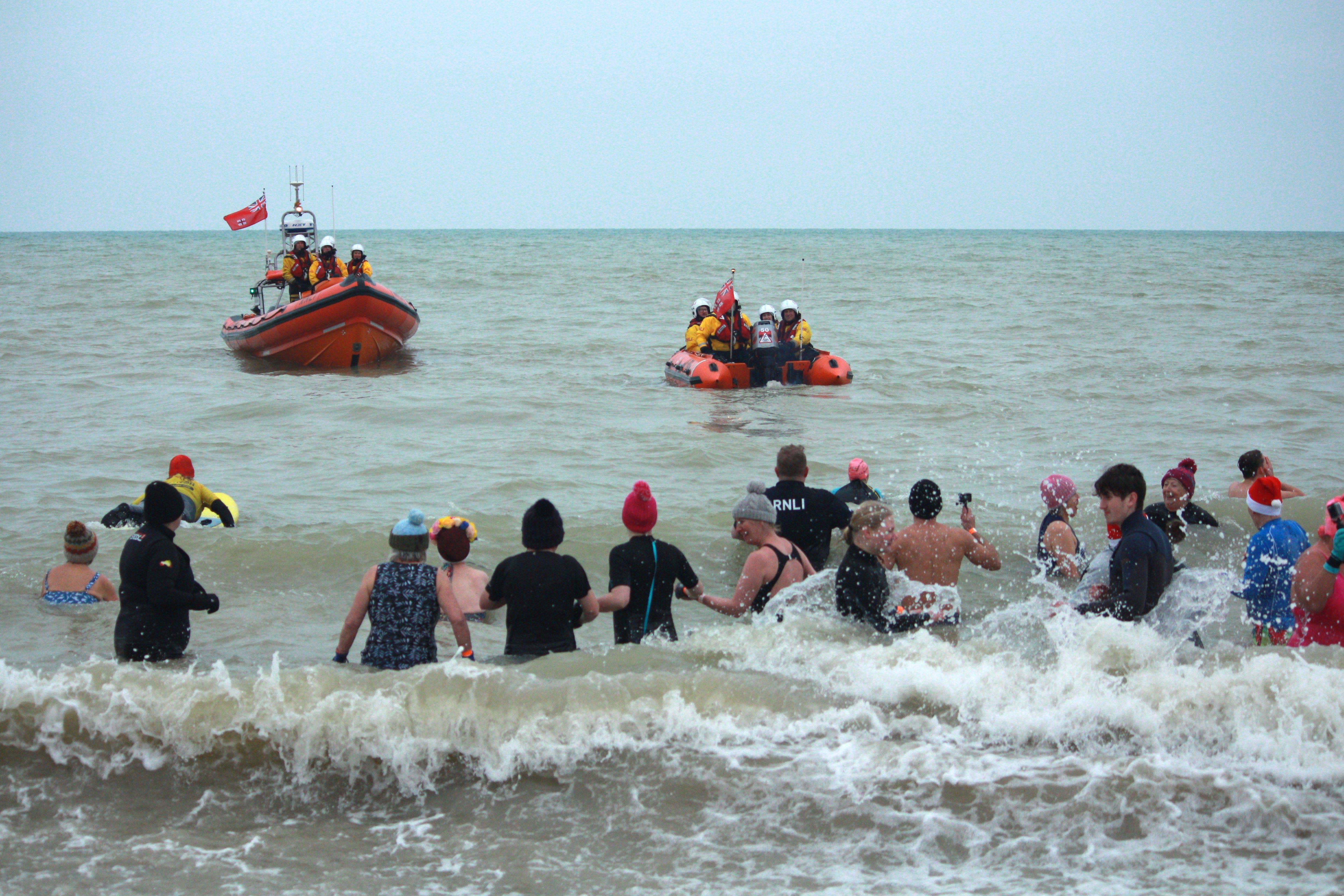 Participants in the water as Littlehampton Lifeboats look on.
