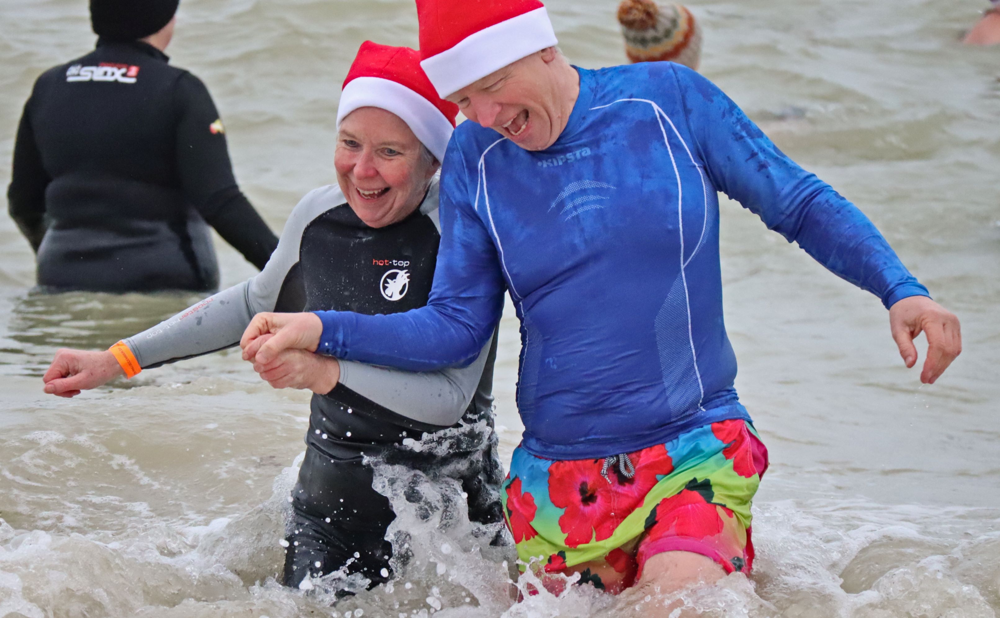Participants laugh together whilst in the water.