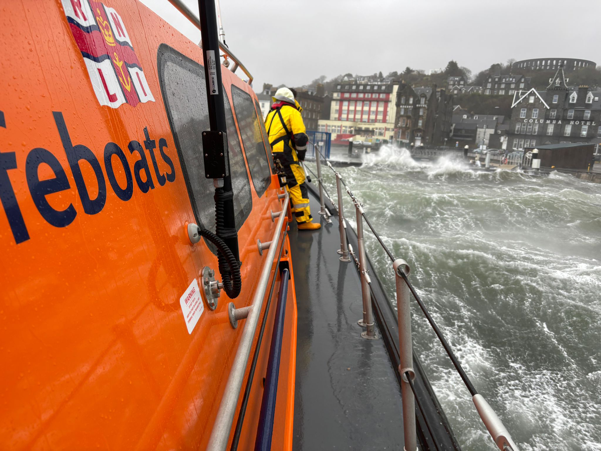 An image taken from the stern of the Shannon class lifeboat showing the heavy seas crashing over the pontoons at Oban's North Pier