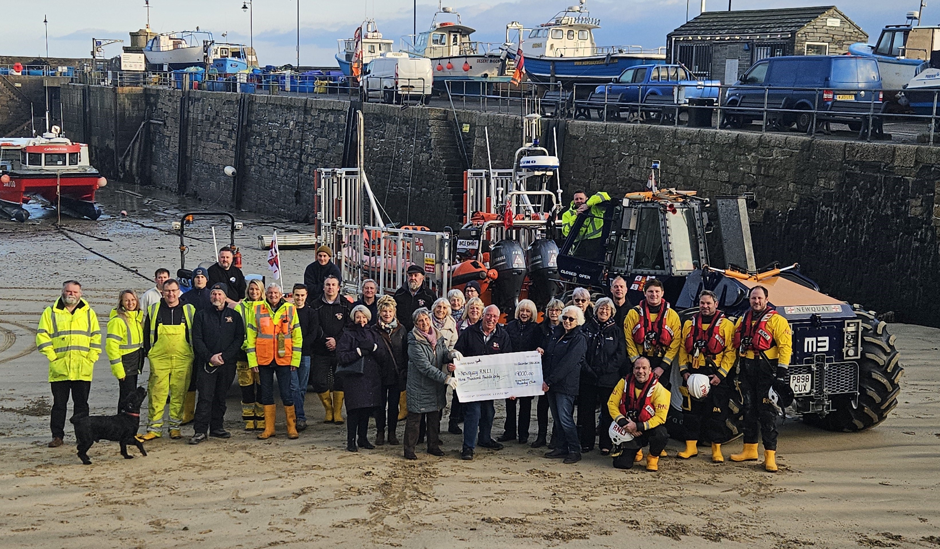 Members of Newquay Thursday Club handover cheque for £9,000 to volunteers from Newquay Lifeboat Station
