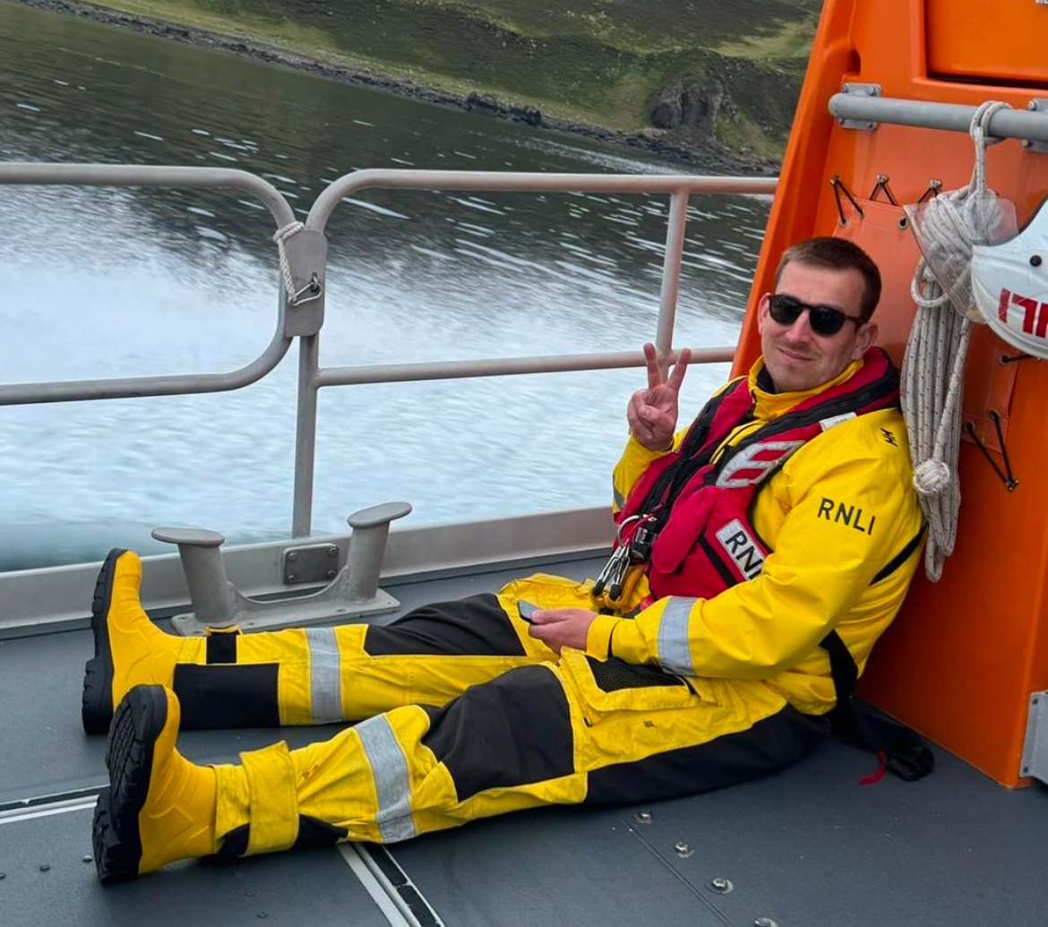 Crew member Adam MacDonald pictured on the deck of Portree lifeboat in less challenging times!