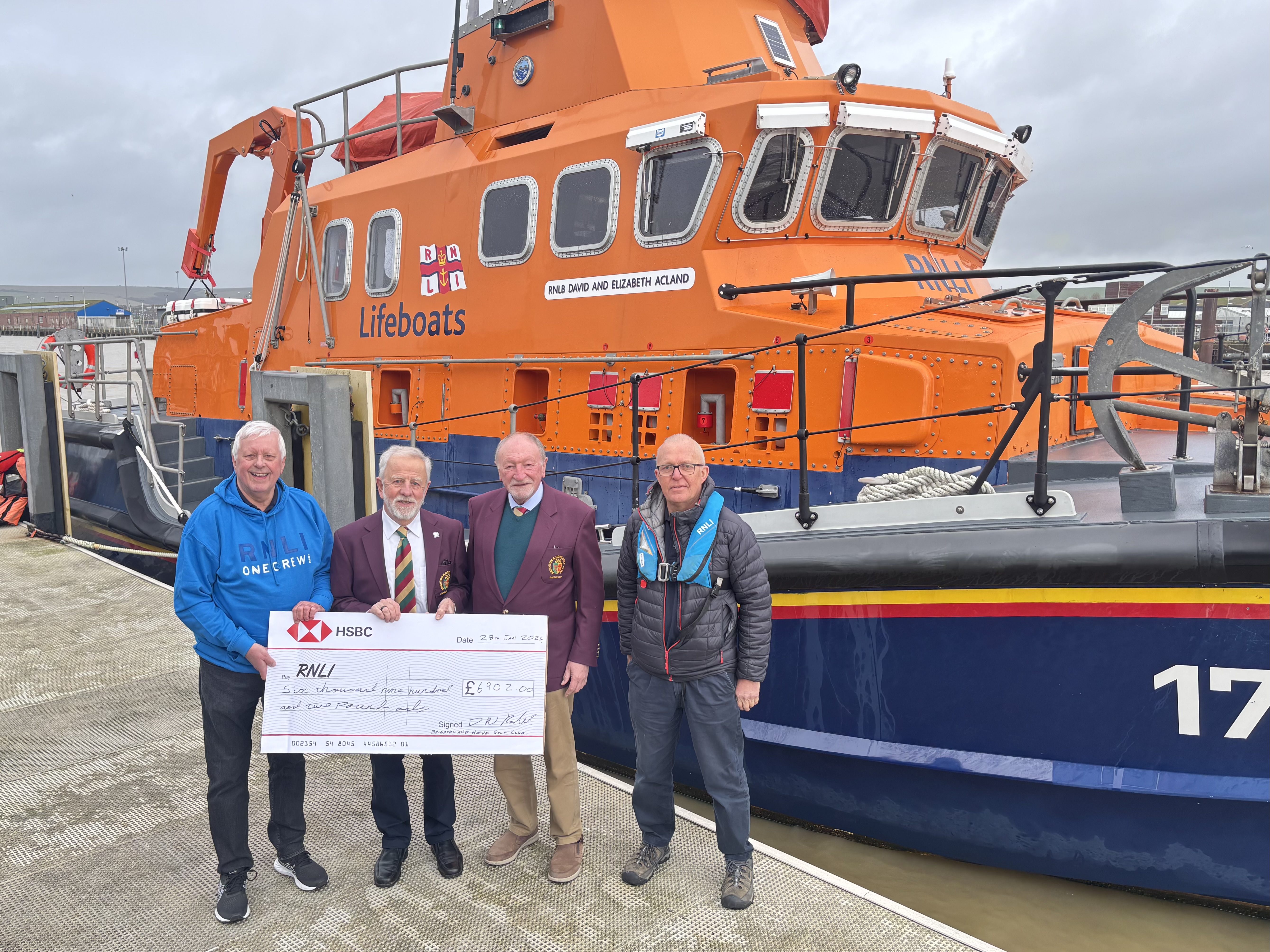 The group standing in front of Newhaven RNLI's Severn Class ALB 17-21