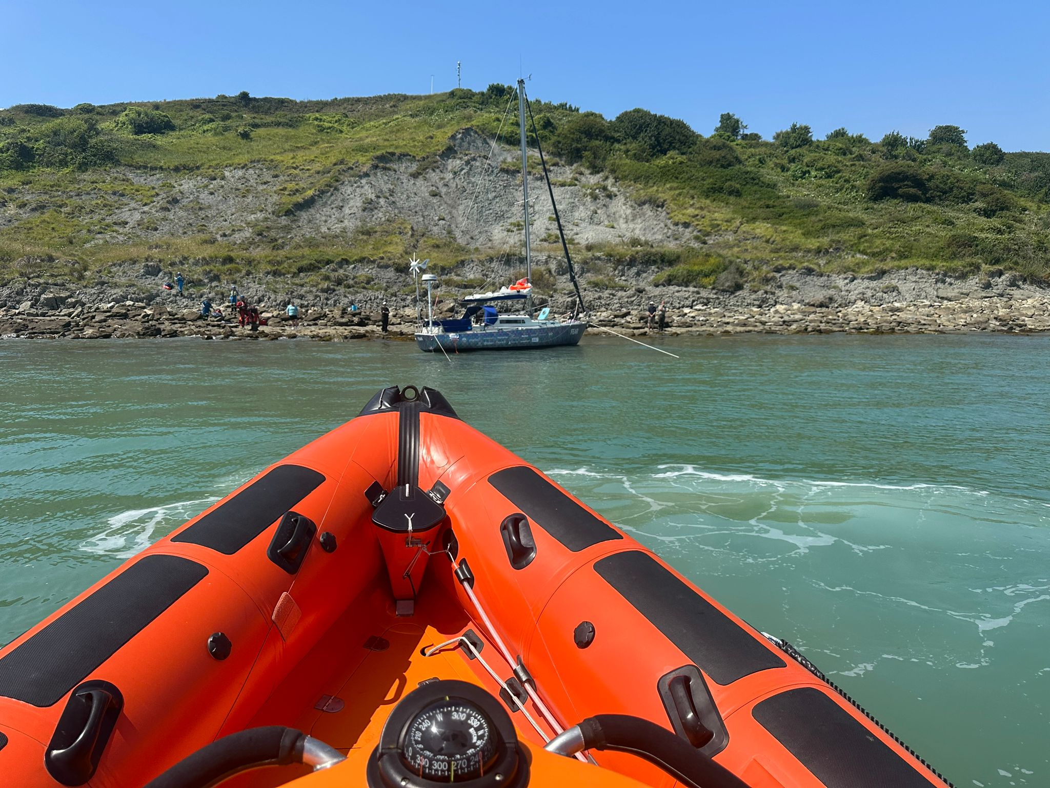 Littlestone lifeboat sitting offshore watching a grounded yacht as she refloats