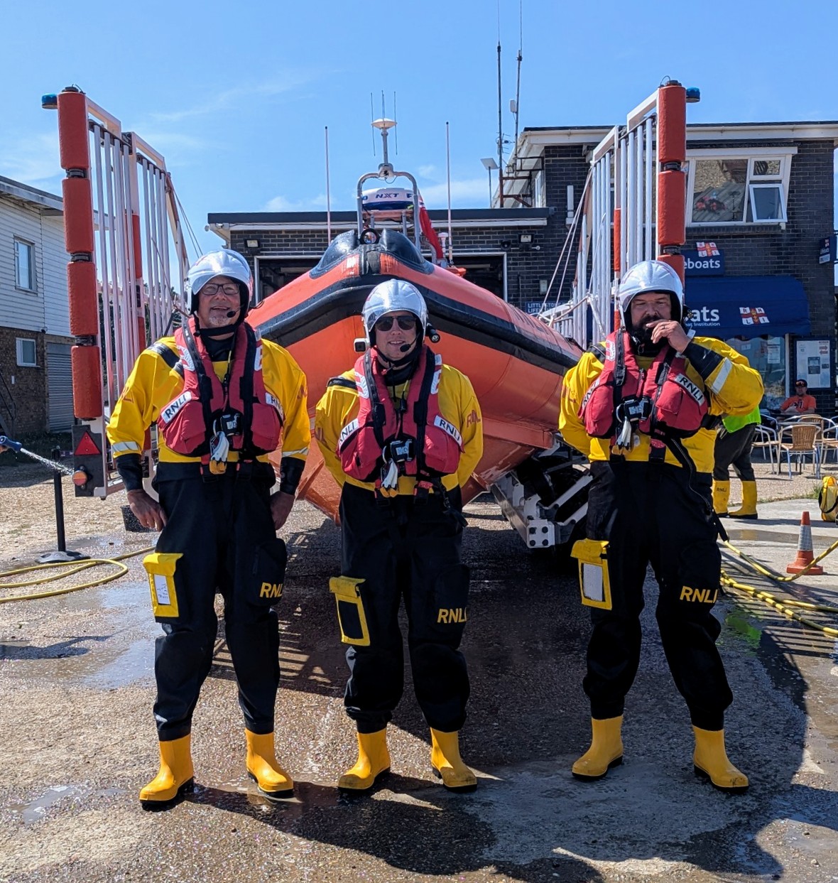 Crew members in bright yellow RNLI dry suits