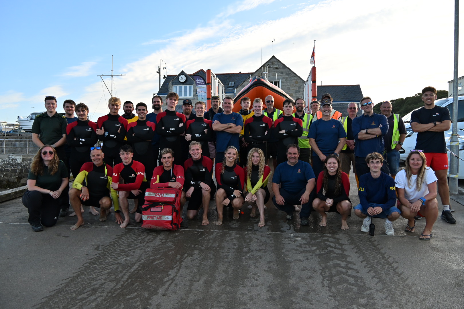 Group of people in front of the lifeboat