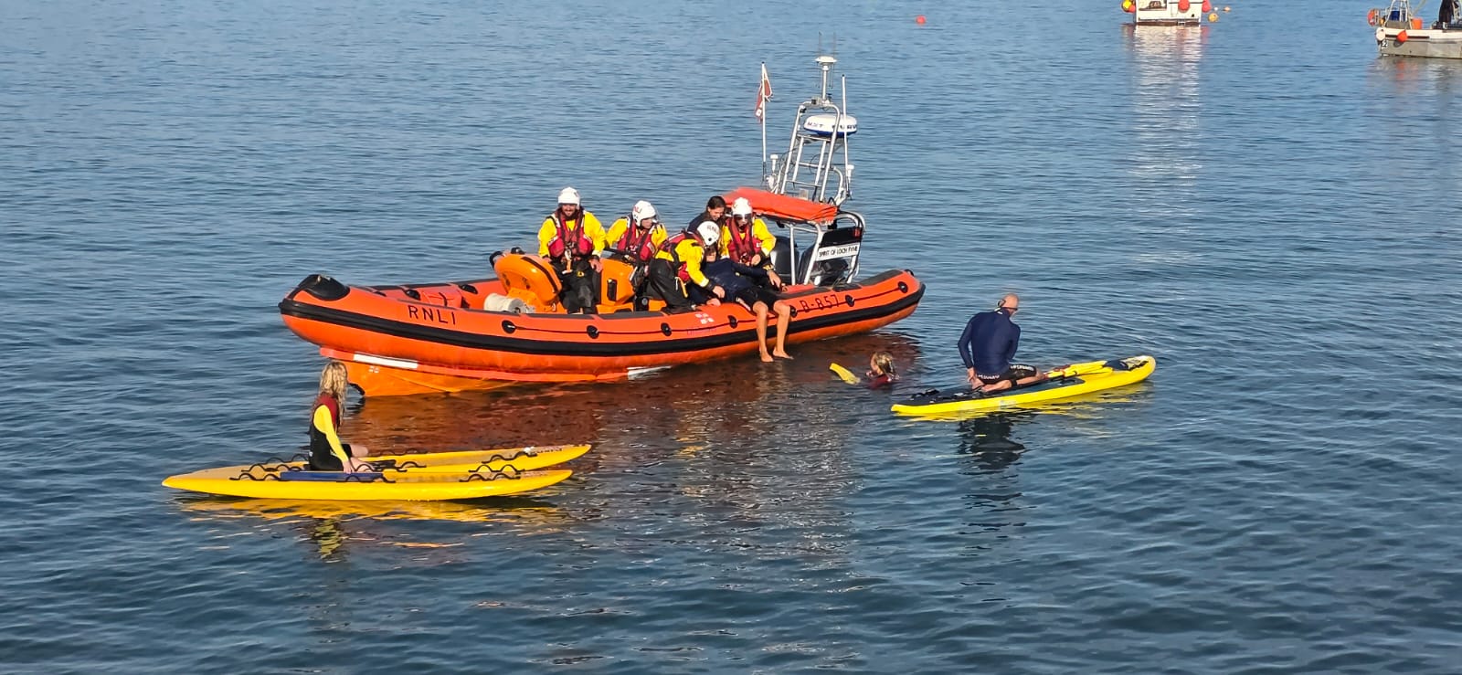 Lifeboat and lifeguards on rescue boards