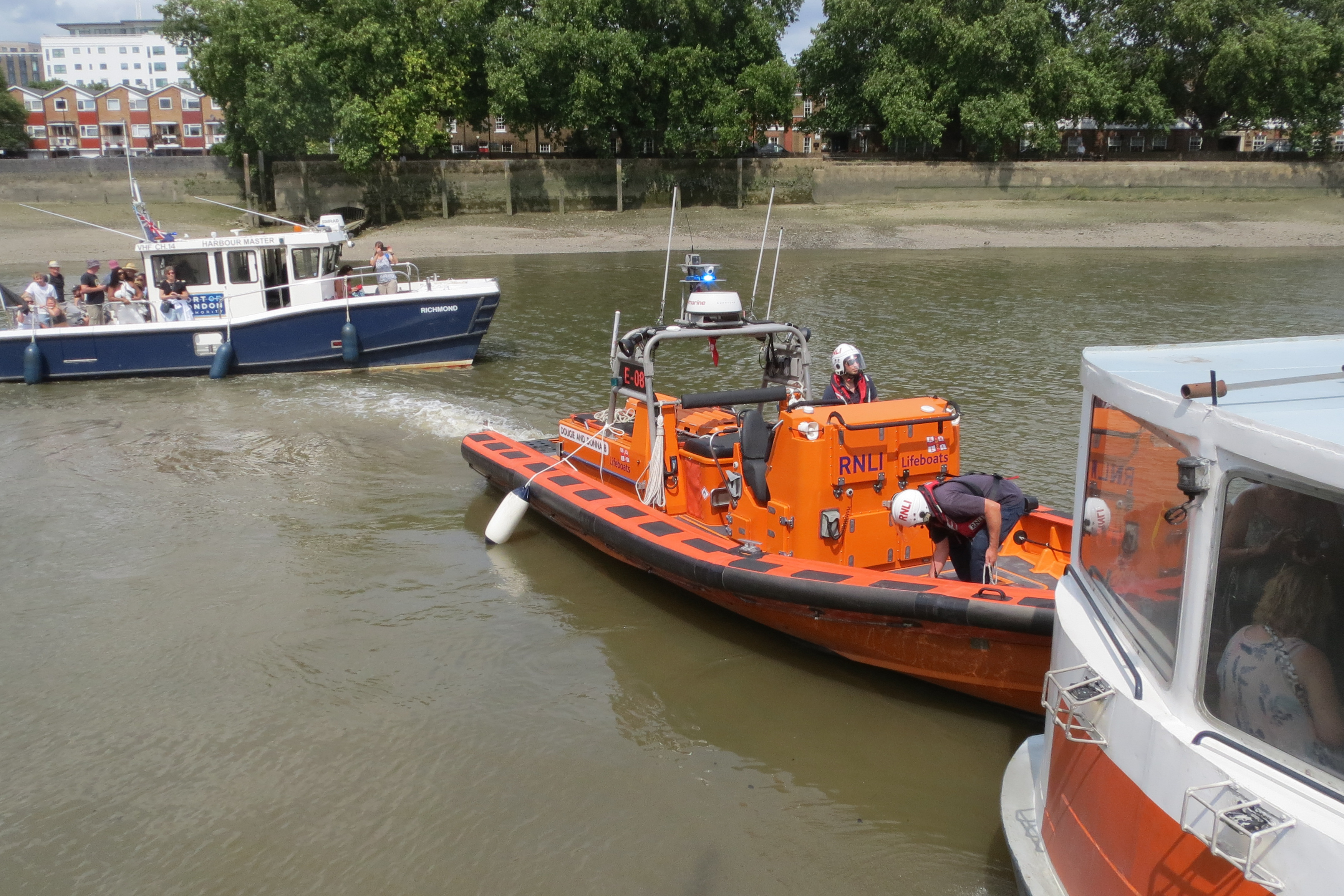 Lifeboat secures the passenger boat to kew Pier while passengers on the 'Richmond' wait to disembark