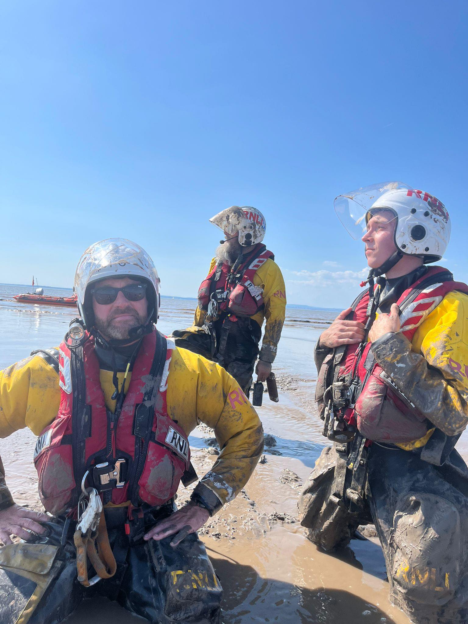Weston RNLI volunteers pictured in the mud during a rescue