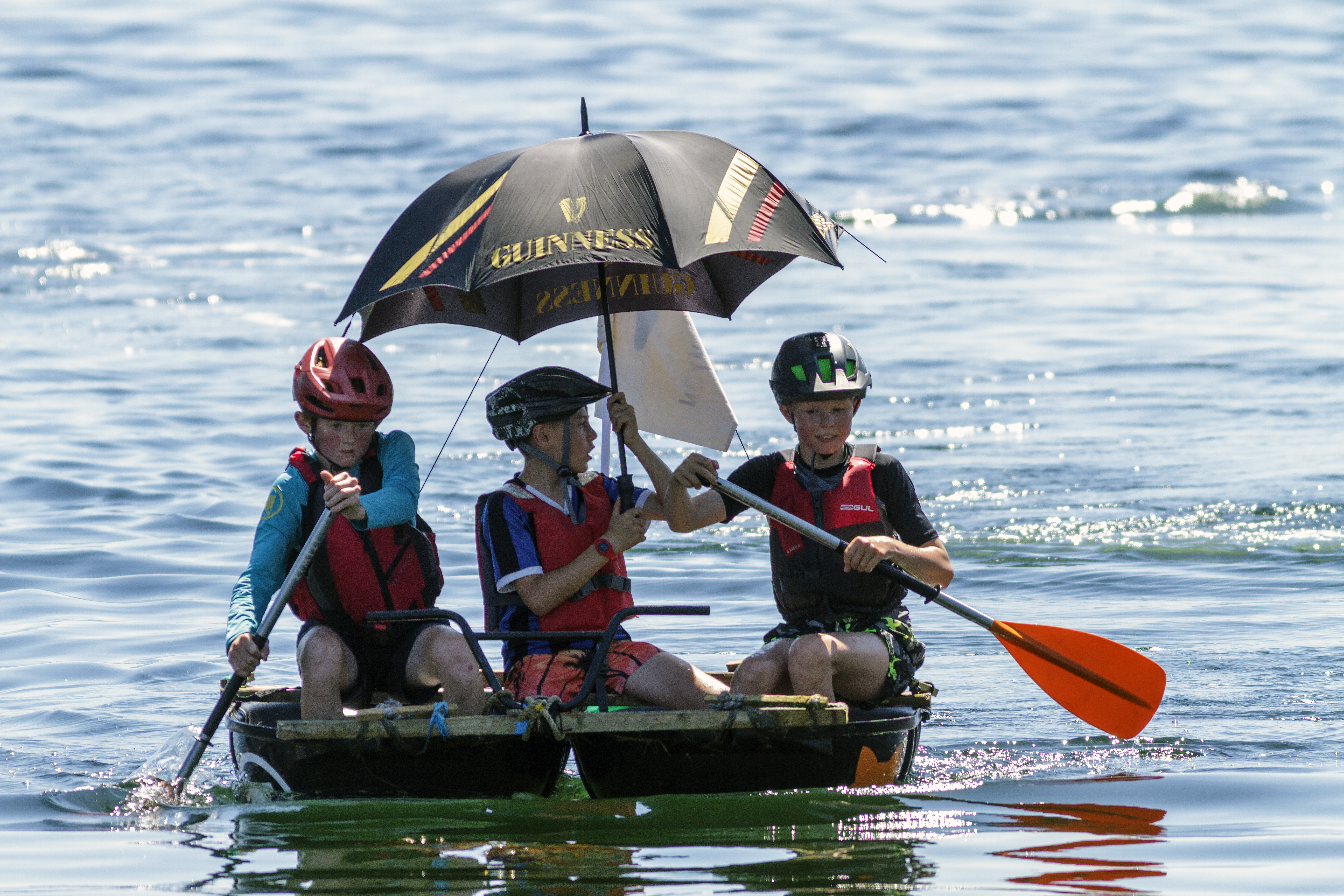 The winning raft being paddled to the finish line to win the junior race