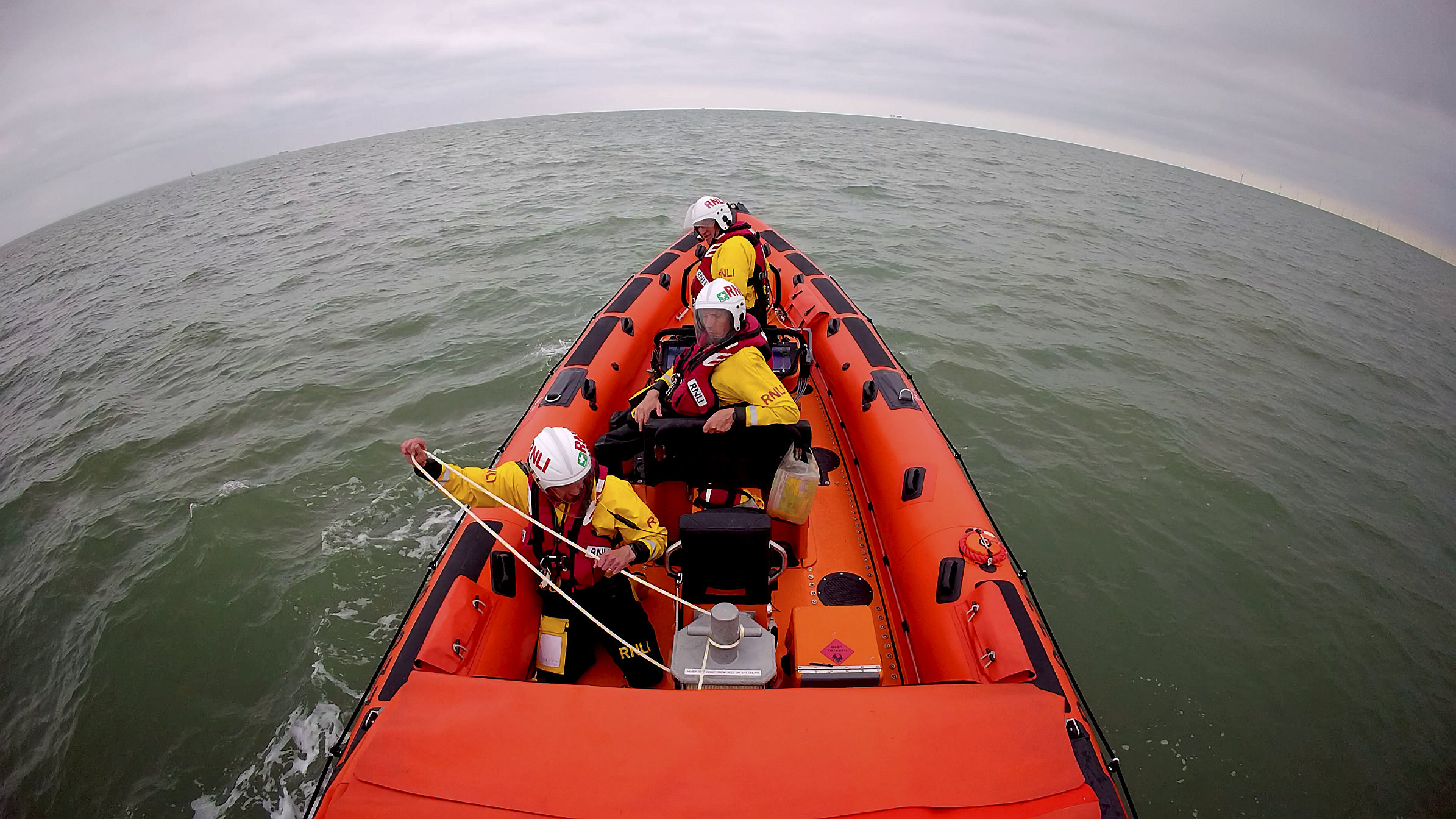 The Whitstable lifeboat crew prepate to tow the yacht that went aground off Sheppey on Sunday morning.