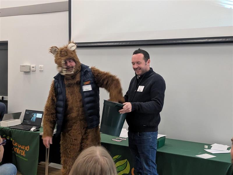 Ground Control employee dressed as a rat to raise funds with a bucket and another employee