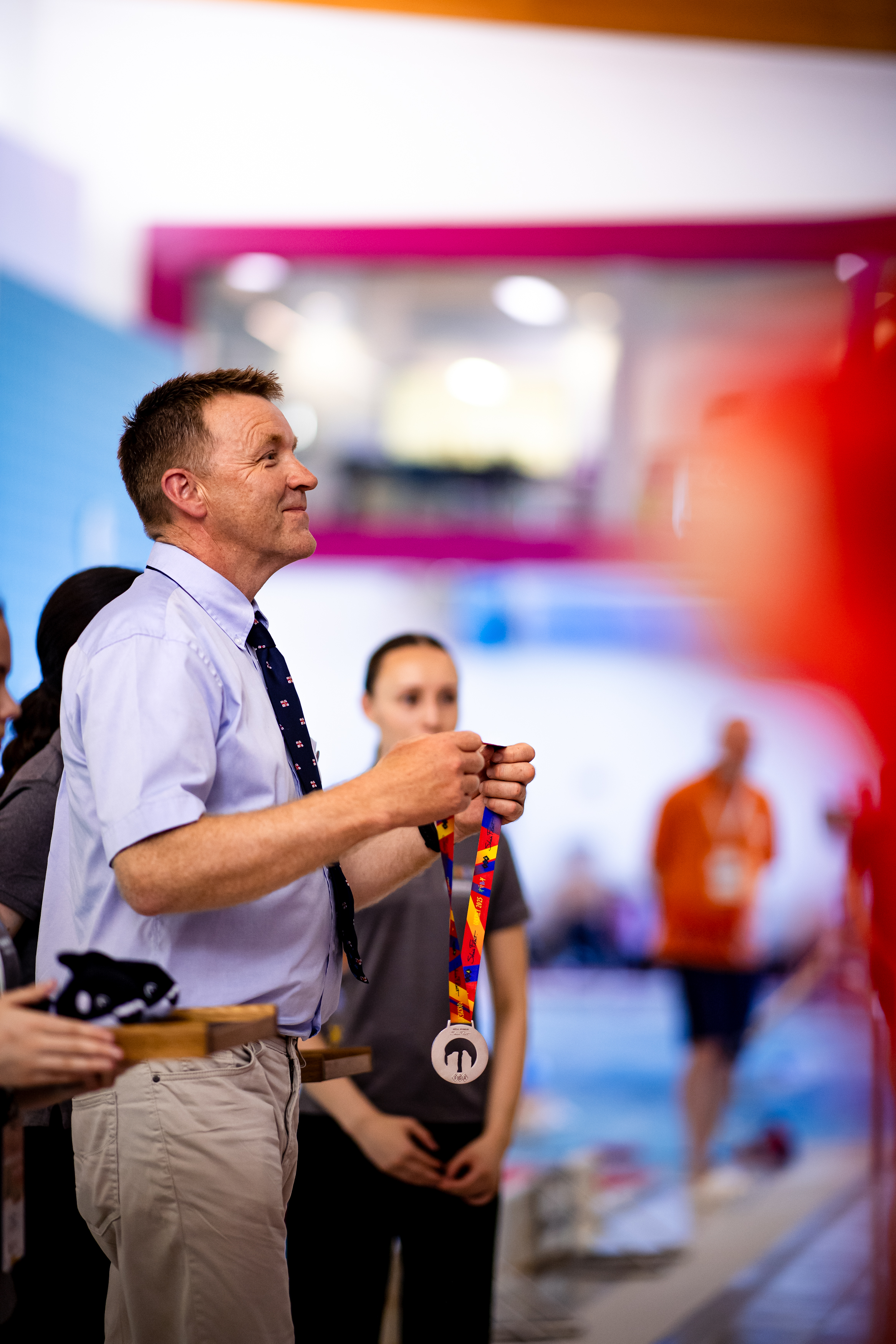 RNLI crew member about to hang a medal round athletes neck