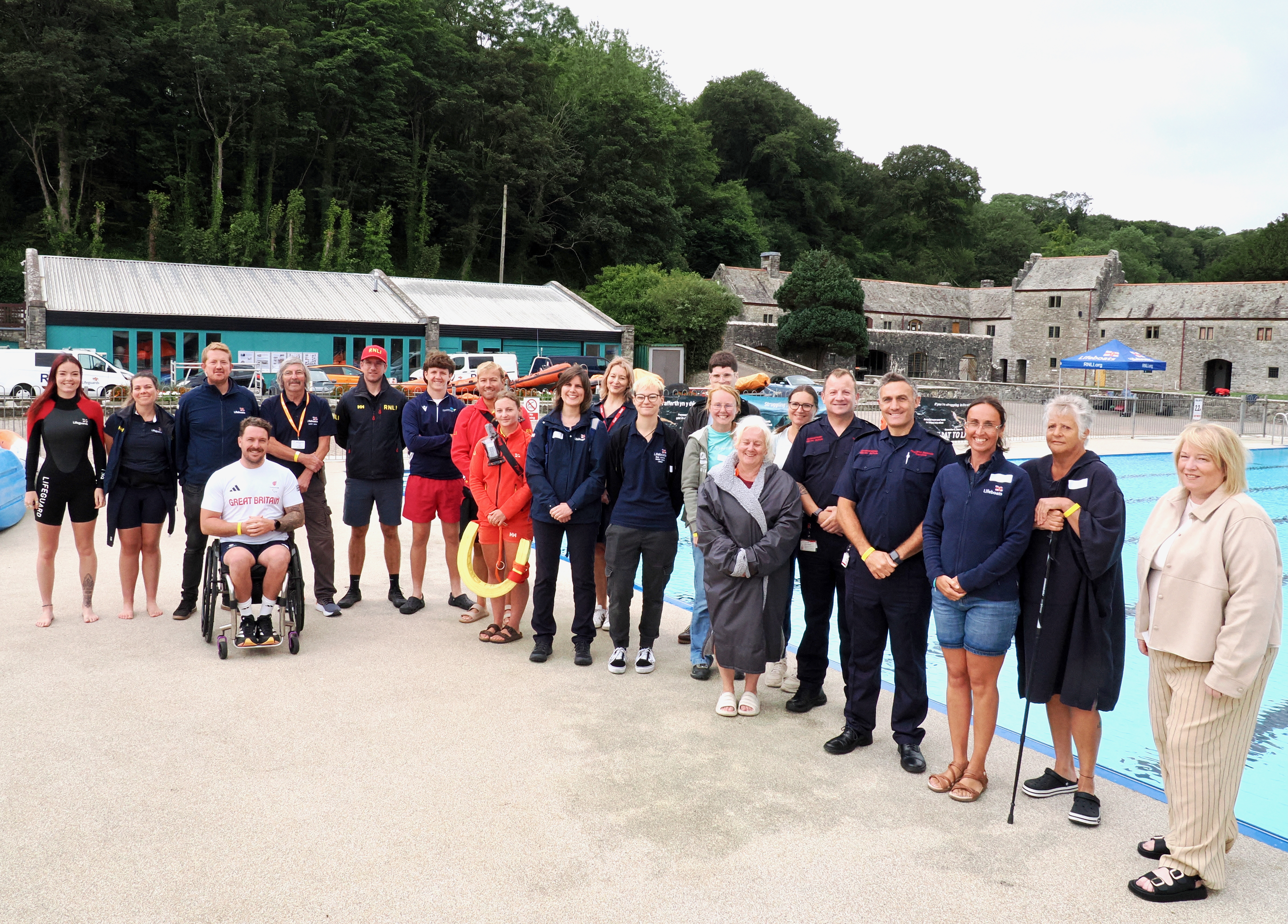 Group shot of everyone stood on the poolside 