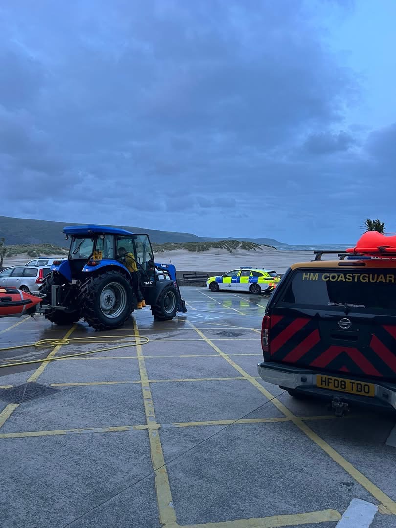 Boathouse forecourt with New Holland tractor, Coastguard truck and police car
