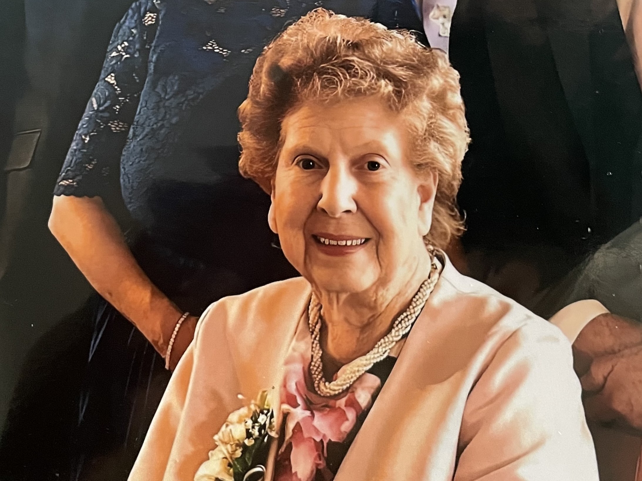 Maudie Manning posed for photo sat in a suit with flower 