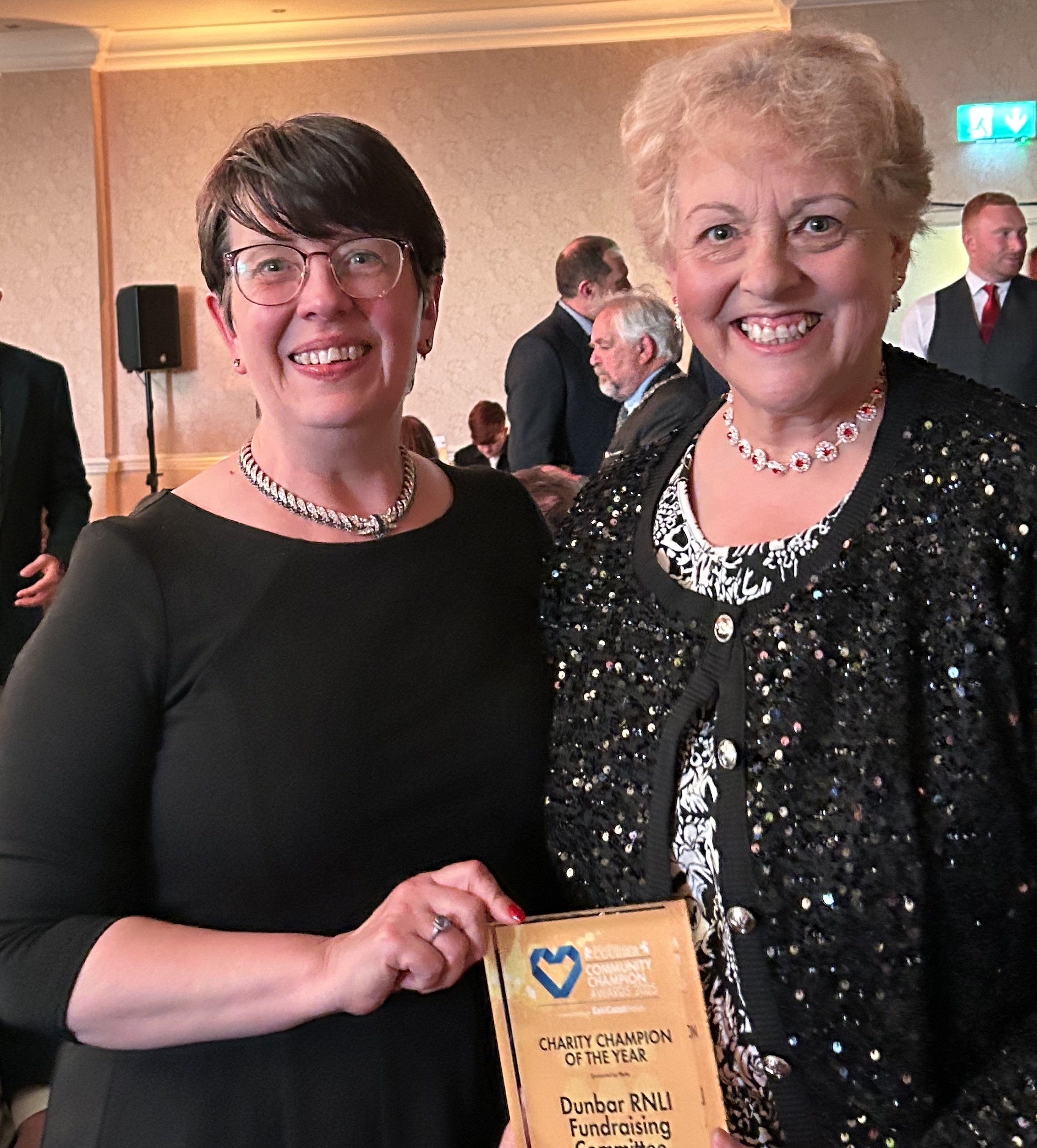 Two women with an award.