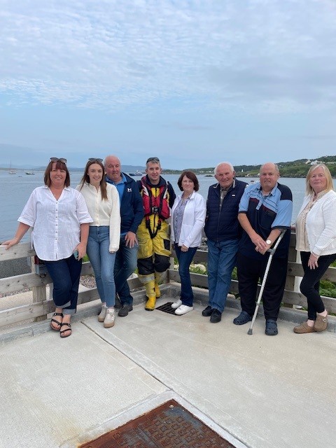 New Arranmore Coxswain pictured surrounded by his family outside the lifeboat station on return from his final assessment.