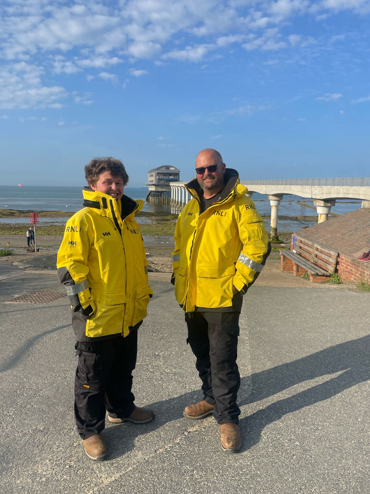 Father and son Fred and James Milne standing in front of Bembridge lifeboat station
