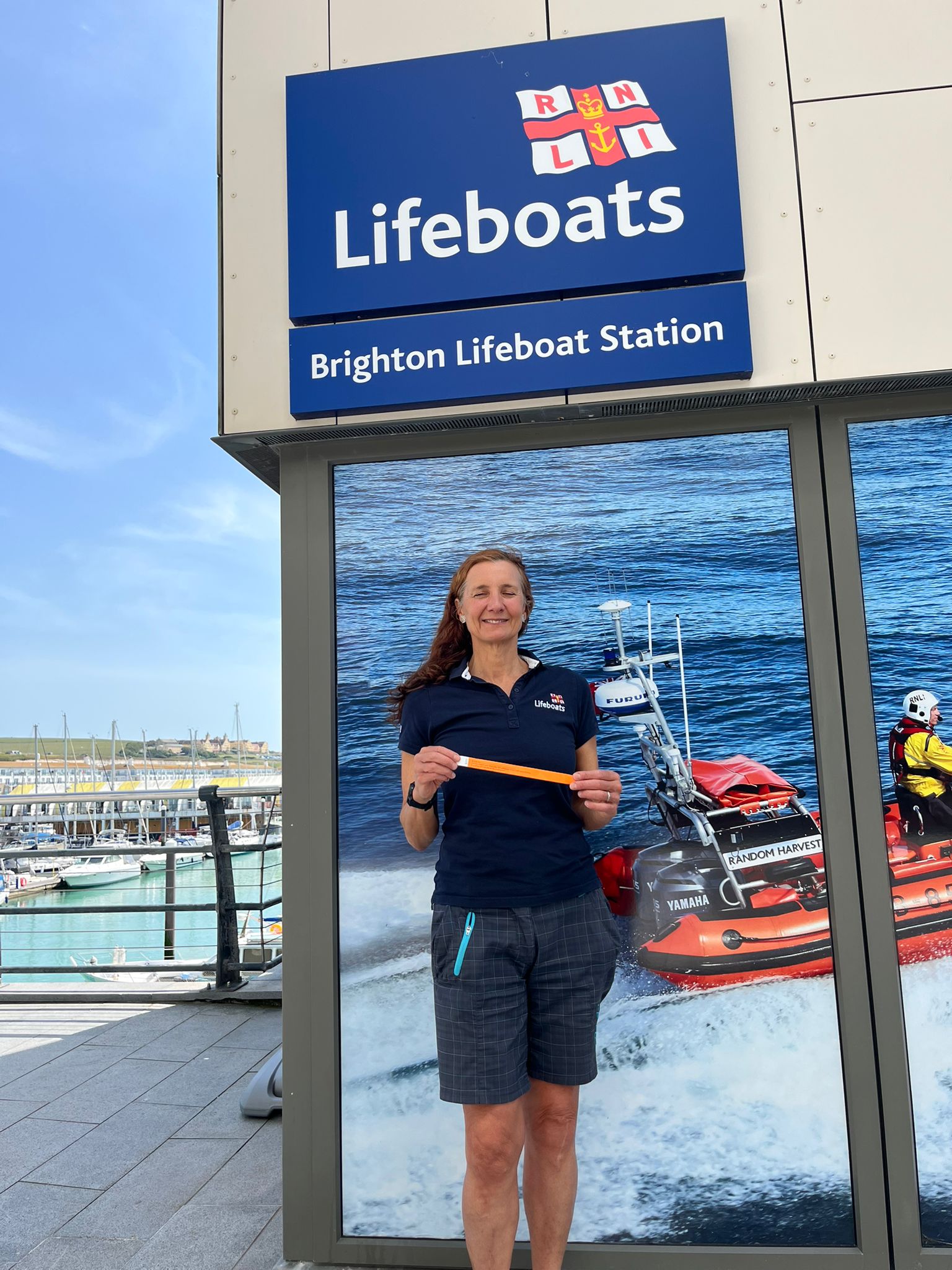 Brighton RNLI Water Safety Advisor - Vicki Linton-Crook - with a child-safe wristband