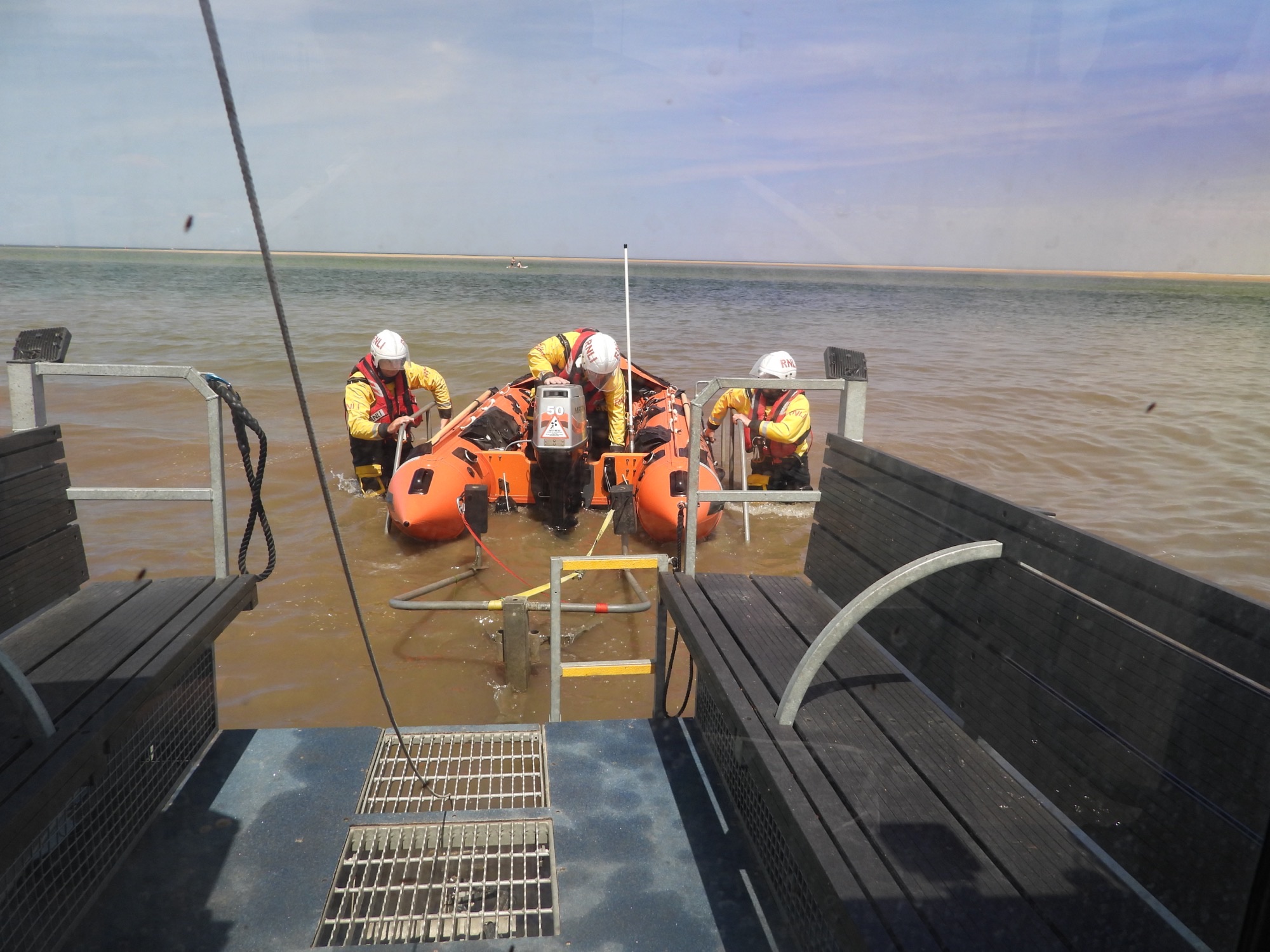 Peter Wilcox launching to people cut off by the incoming tide three crew and soft trak launching lifeboat
