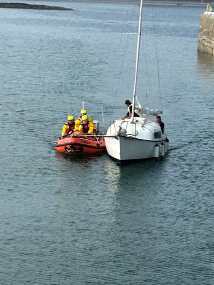 Port St Mary inshore lifeboat entering harbour with casualty