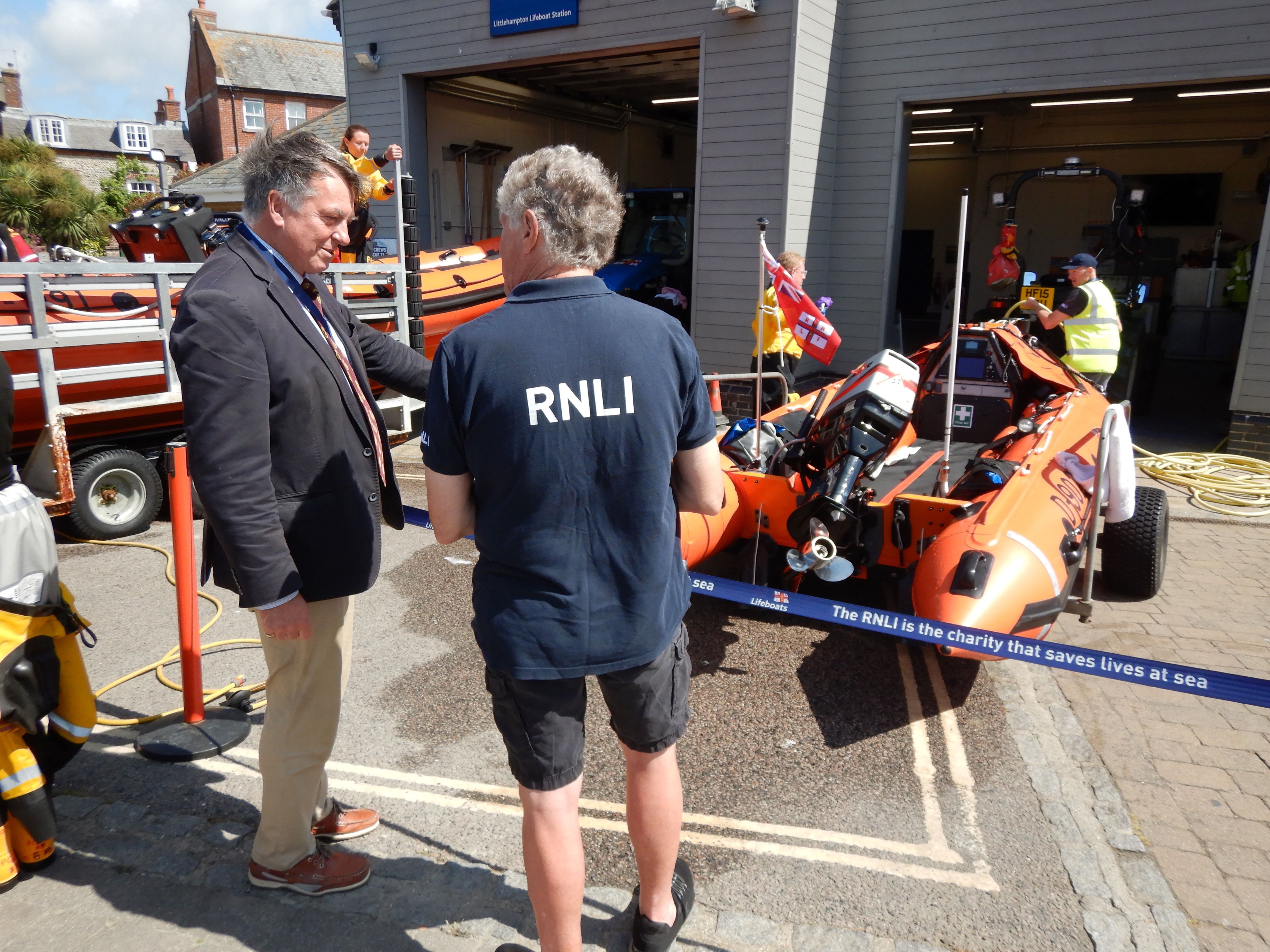 Dr Tim Fooks, High Sheriff of West Sussex (left) and Nick White, Lifeboat Operations Manager at Littlehampton lifeboat station (right) discuss the station's newest lifeboat D-902 Spirit of Fidelity.