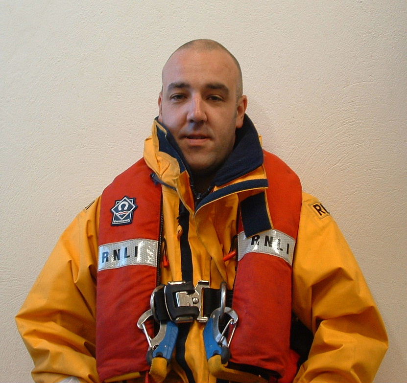 a lifeboat crew member wearing a life-jacket and water proof coat