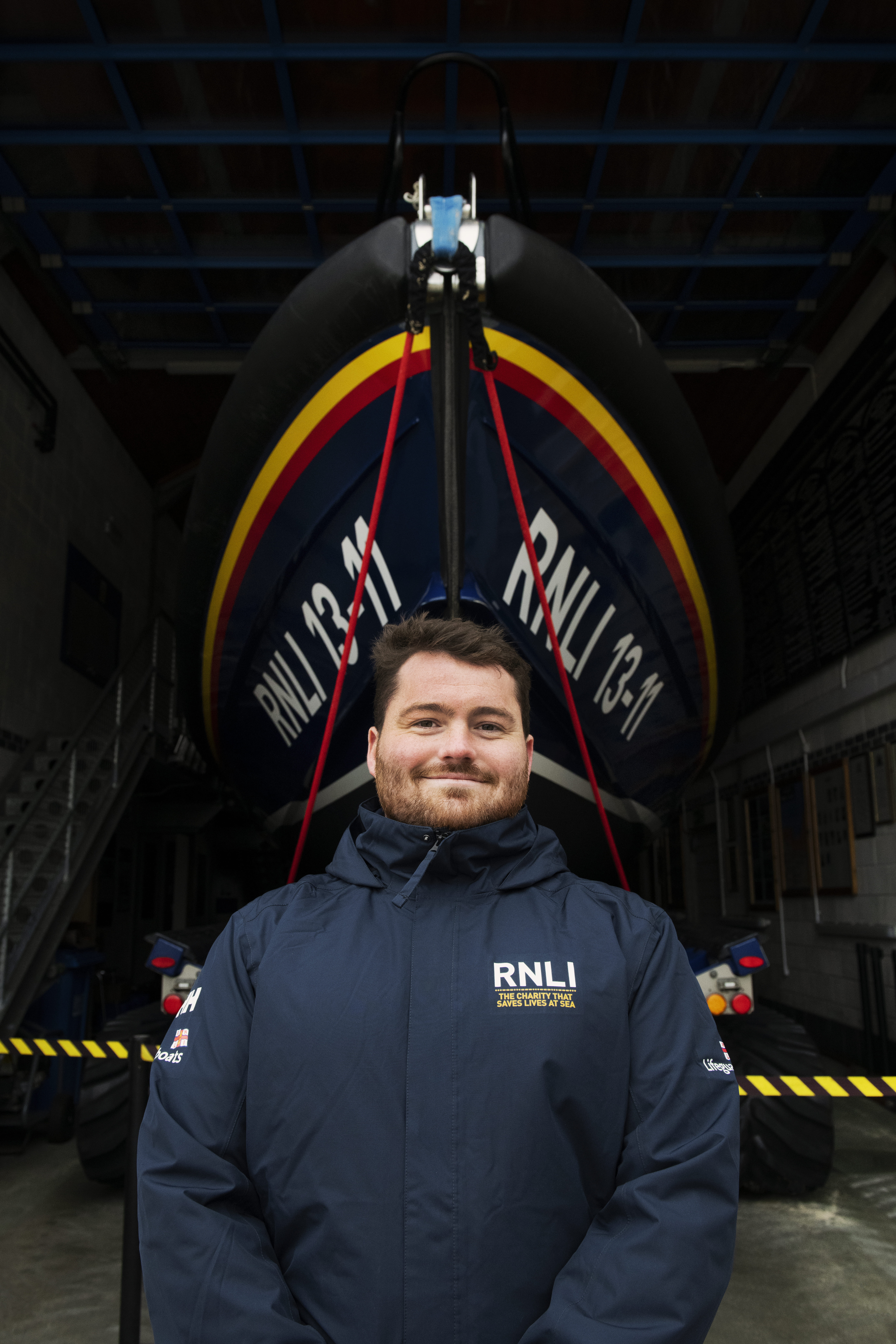 A face-to-face fundraiser standing infront of a Shannon Class lifeboat