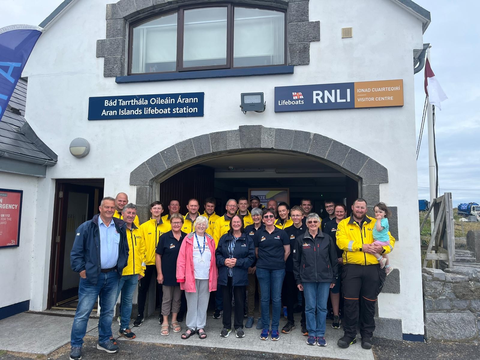 Aran Island Volunteers standing outside the Station and Shop 