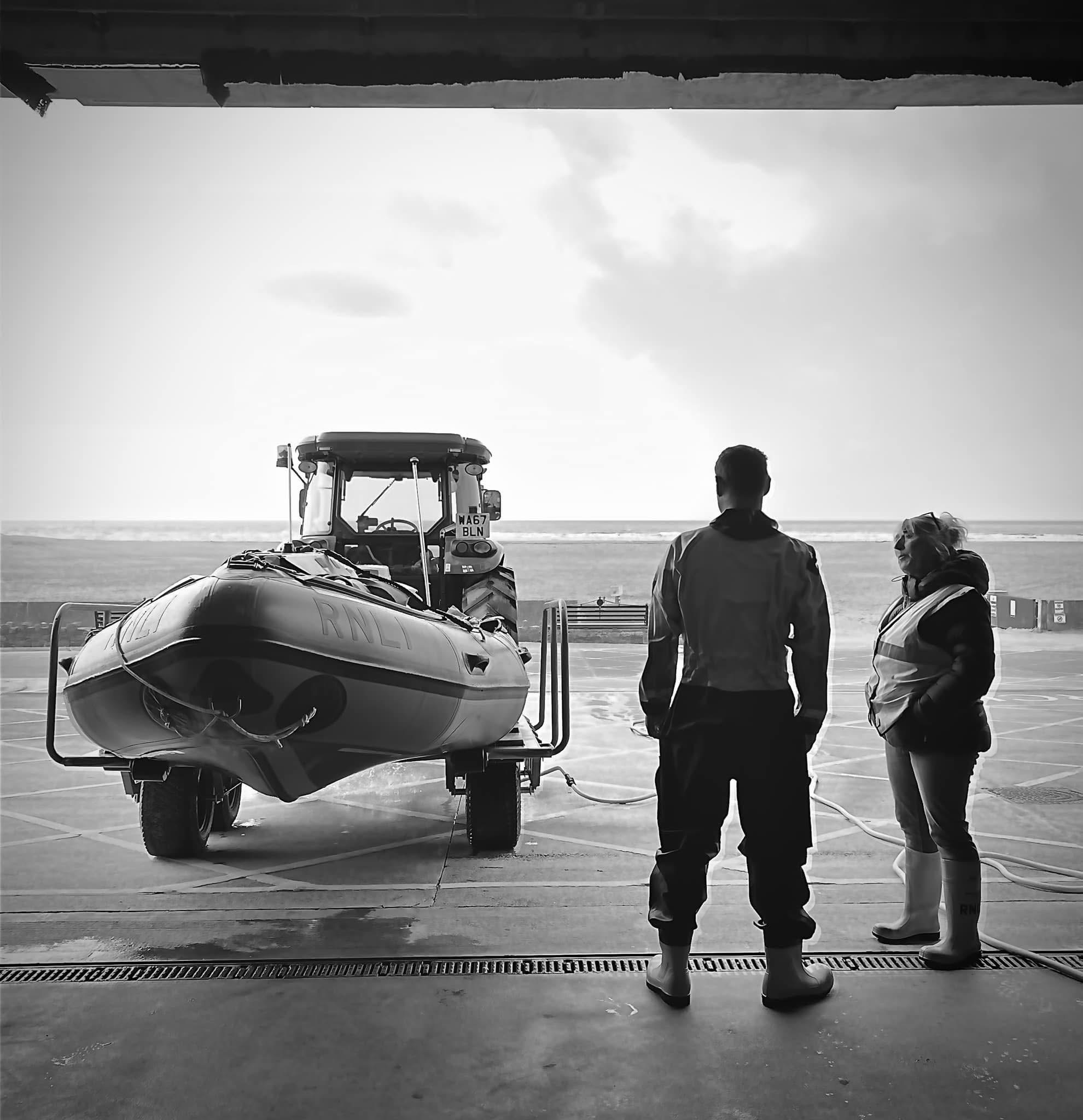 Reflecting the shout. Black and white photo of crew with lifeboat