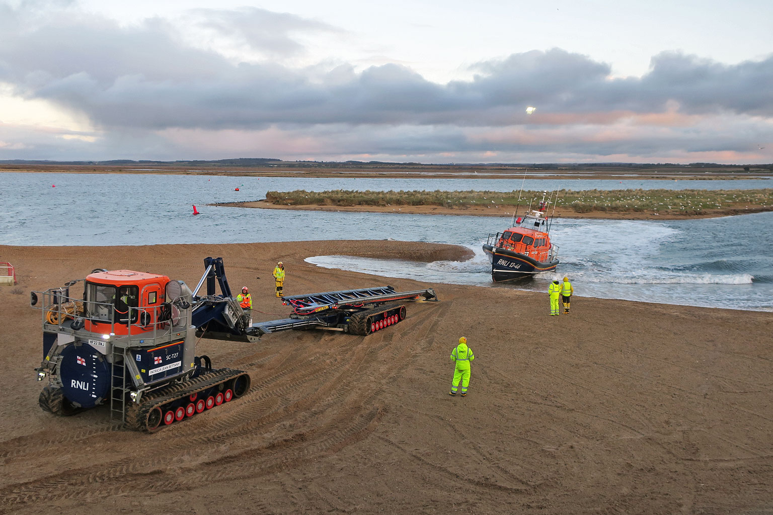 Wells RNLI Shannon class lifeboat beach recovery. Slars and lifeboat on beach being recovered after rescue