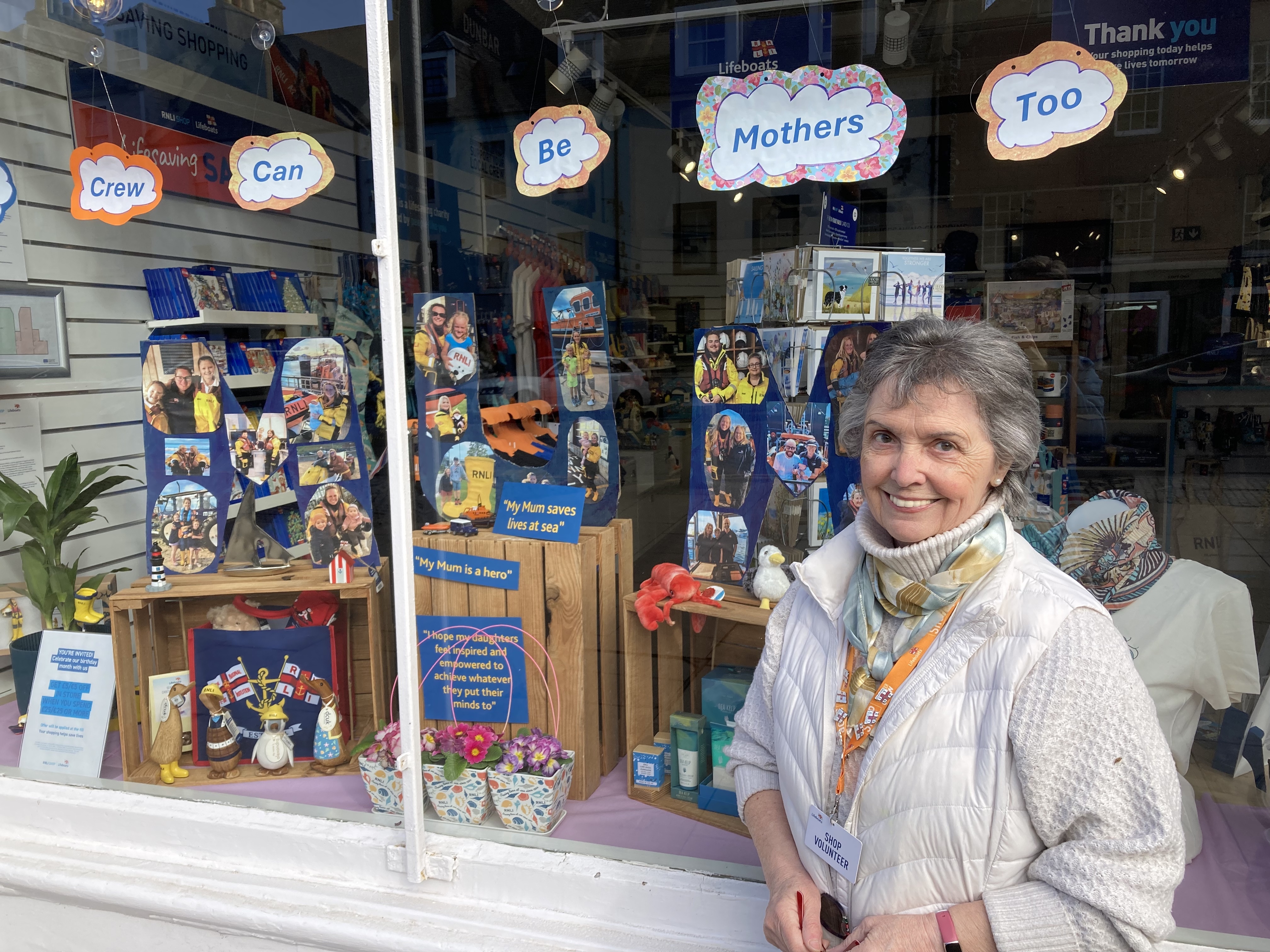 Woman outside shop.