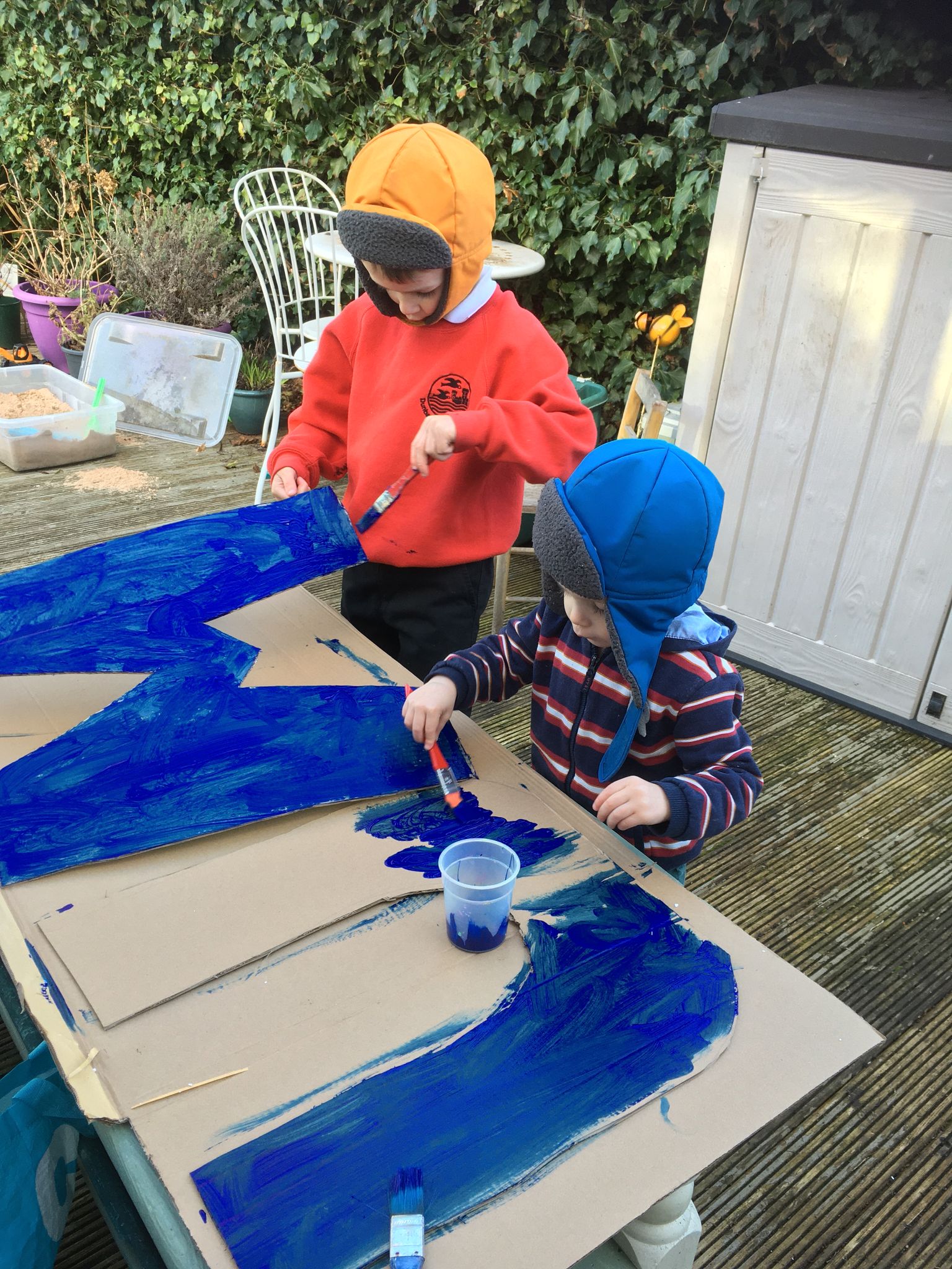 Two boys painting.