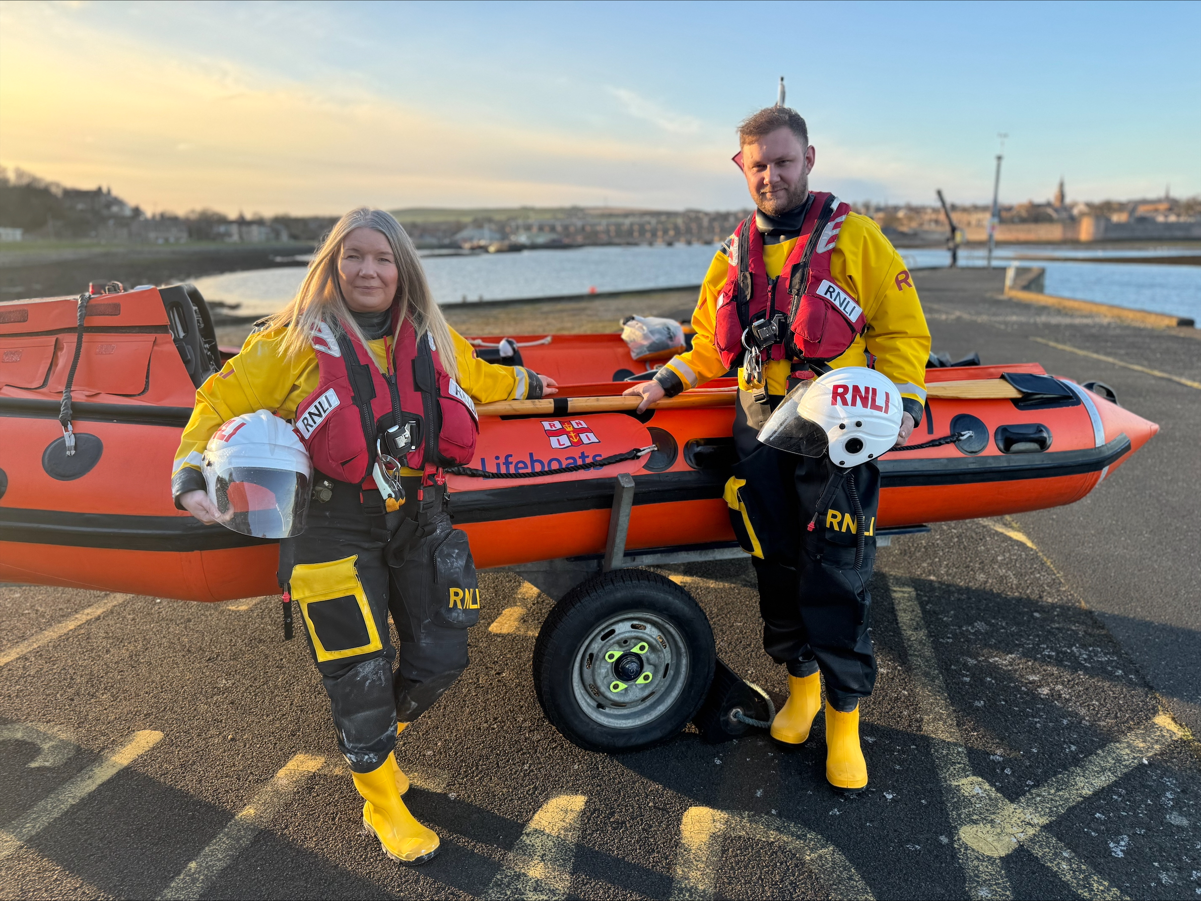 RNLI Berwick-Upon-Tweed Mother and son crew members Shona Richardson and Sean Dixon Infront of D class lifeboat in full inshore lifeboat kit