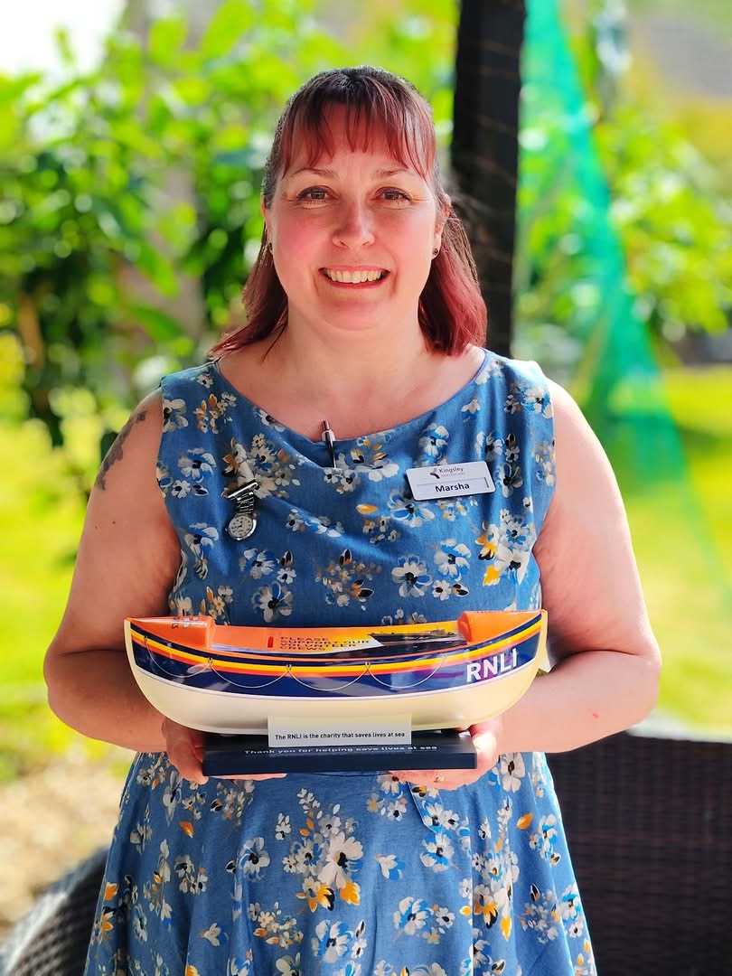 Marsha Hughes at Thorp House care home with RNLI charity box