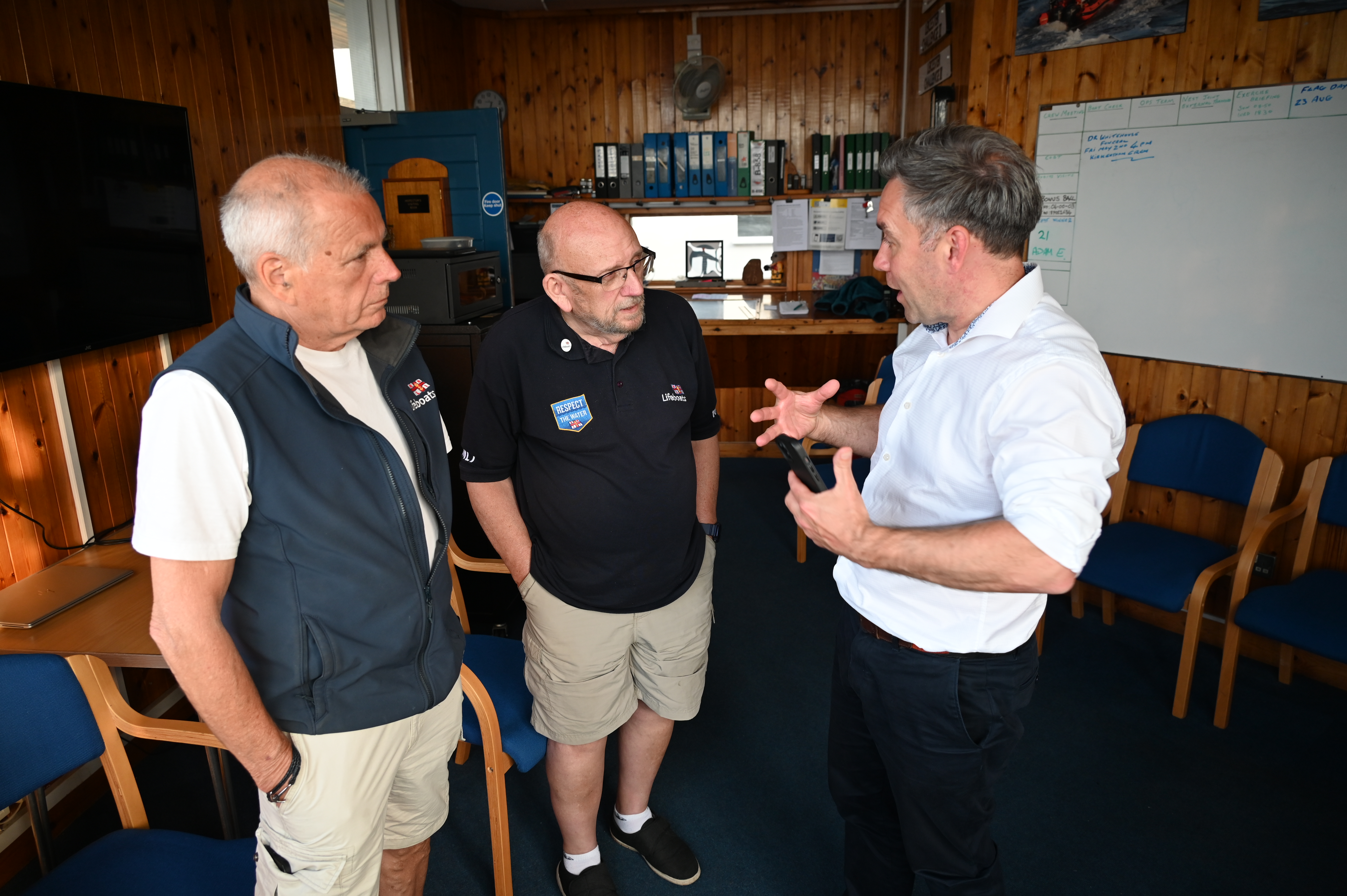 John Reece and Rob Eddon speaking with Gareth Morrison Head of RNLI Water Safety