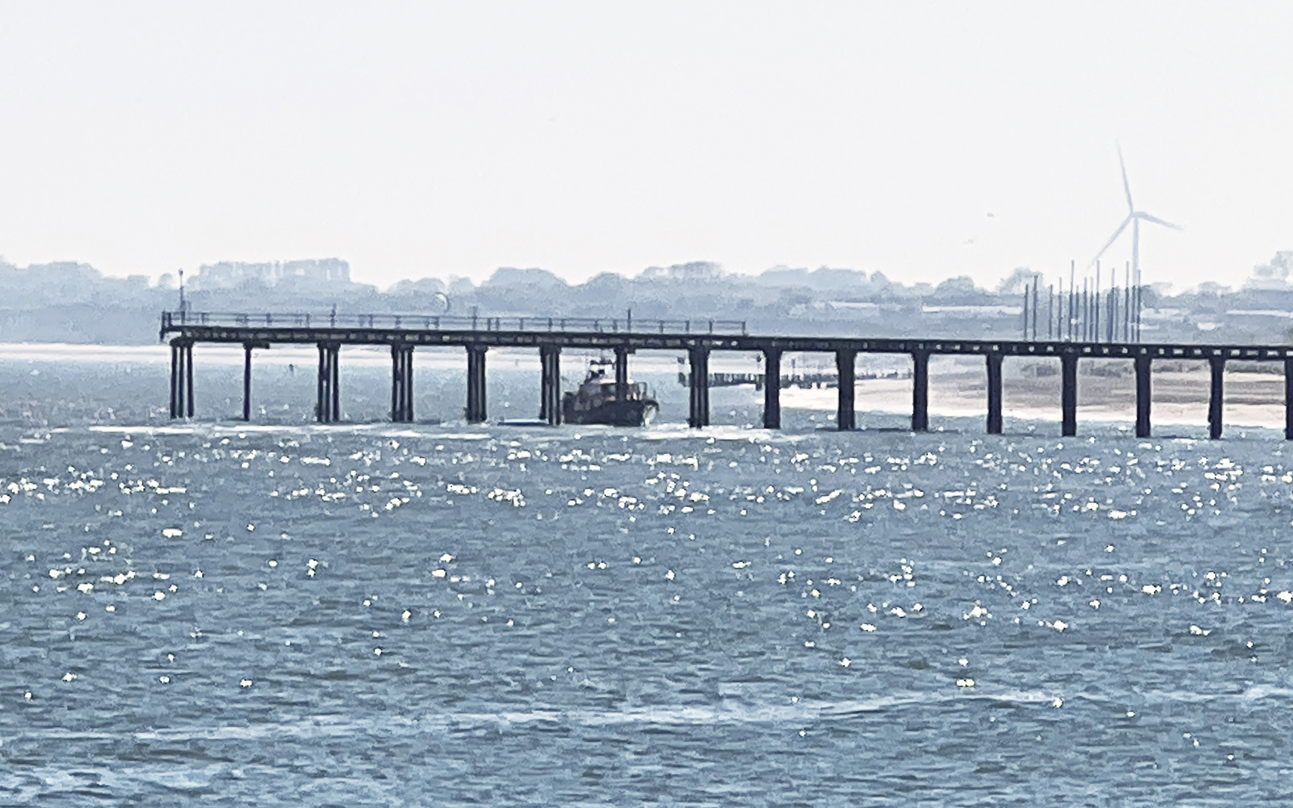 Lowestoft RNLI Lifeboat rescuing a paddle boarder from under Claremont Pier