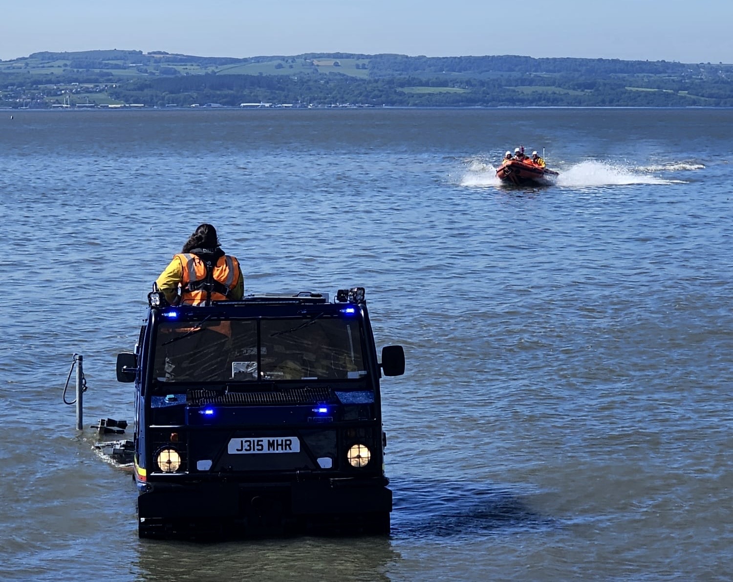 The lifeboat can be seen approaching the BV launch vehicle for recovery in West Kirby