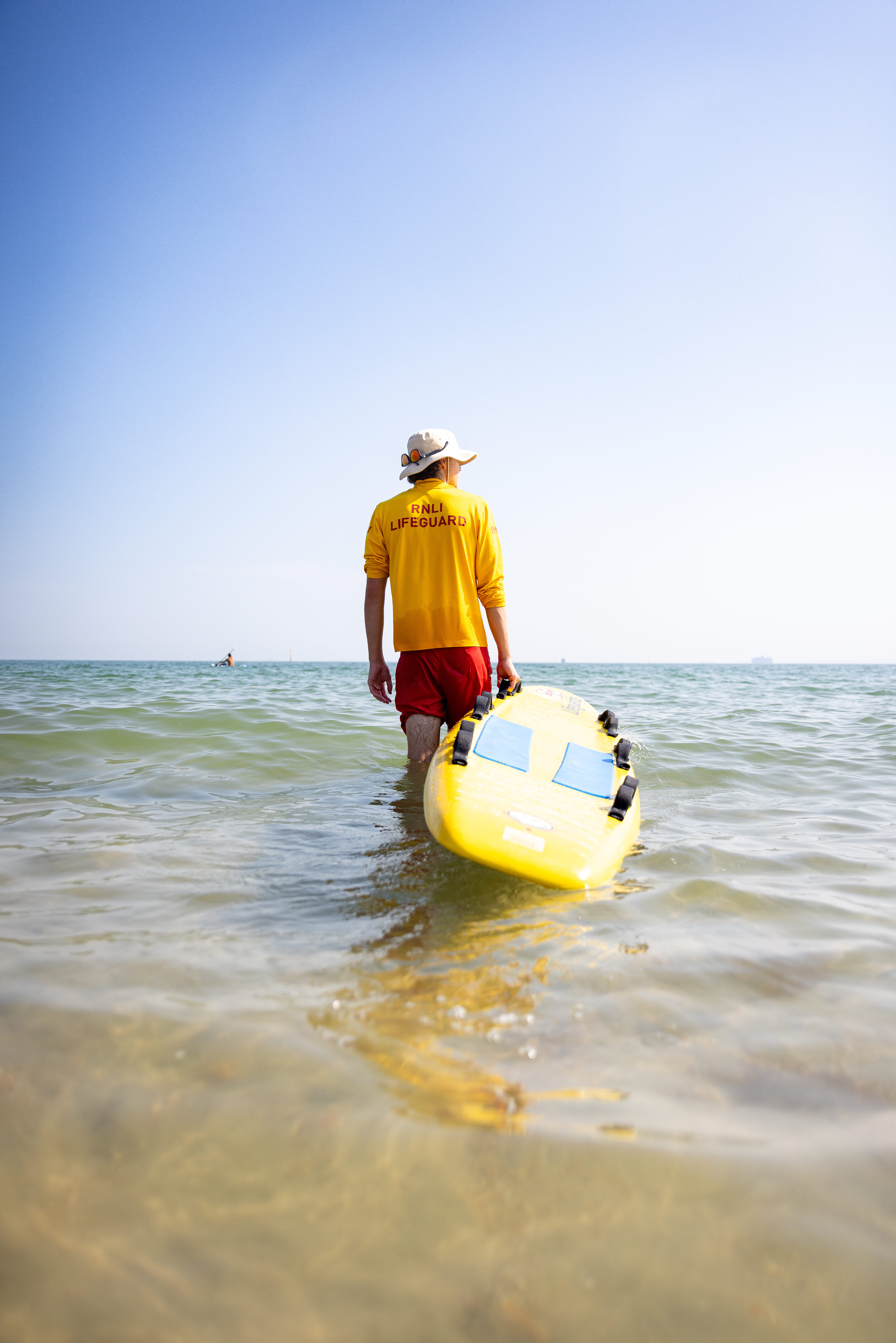 An RNLI lifeguard keeping watch over beach goers
